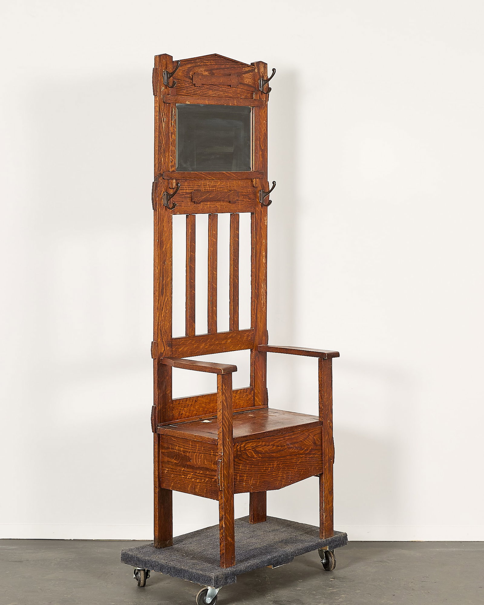 Vintage Arts & Crafts Mission Style Hall Tree: Vintage Arts & Crafts or Mission-style hall tree with a mirror, four coat hooks, and built-in storage seat. Height: 72 in x width: 24 1/4 in x width: 15 1/2 in.