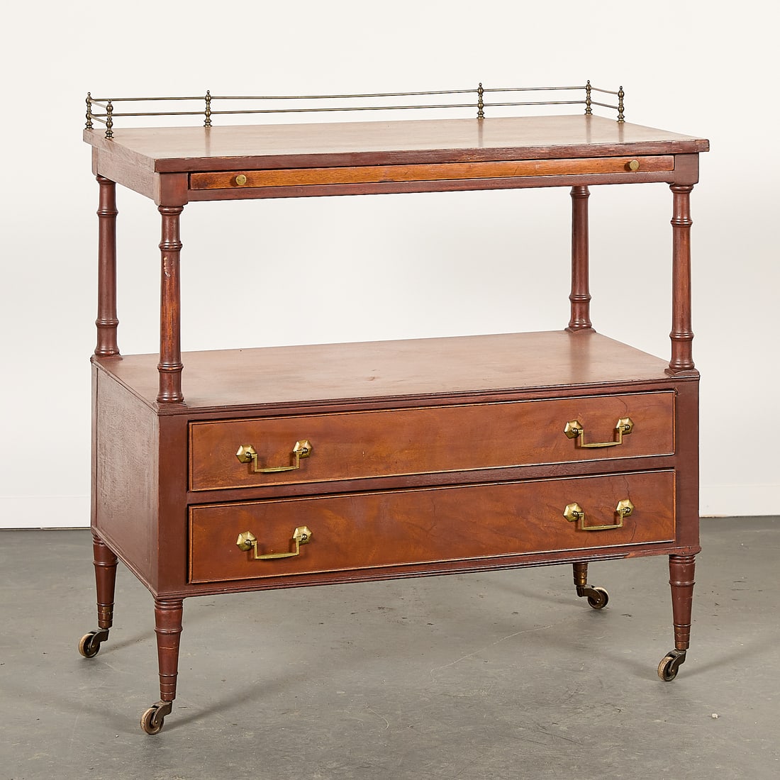 Morganton Co. Georgian Style Two Drawer Server: Morganton Furniture Company, North Carolina, United States. Georgian style wooden two drawer server with a pull-out tray, 20th century. Featuring a brass gallery rail along the work surface, brass