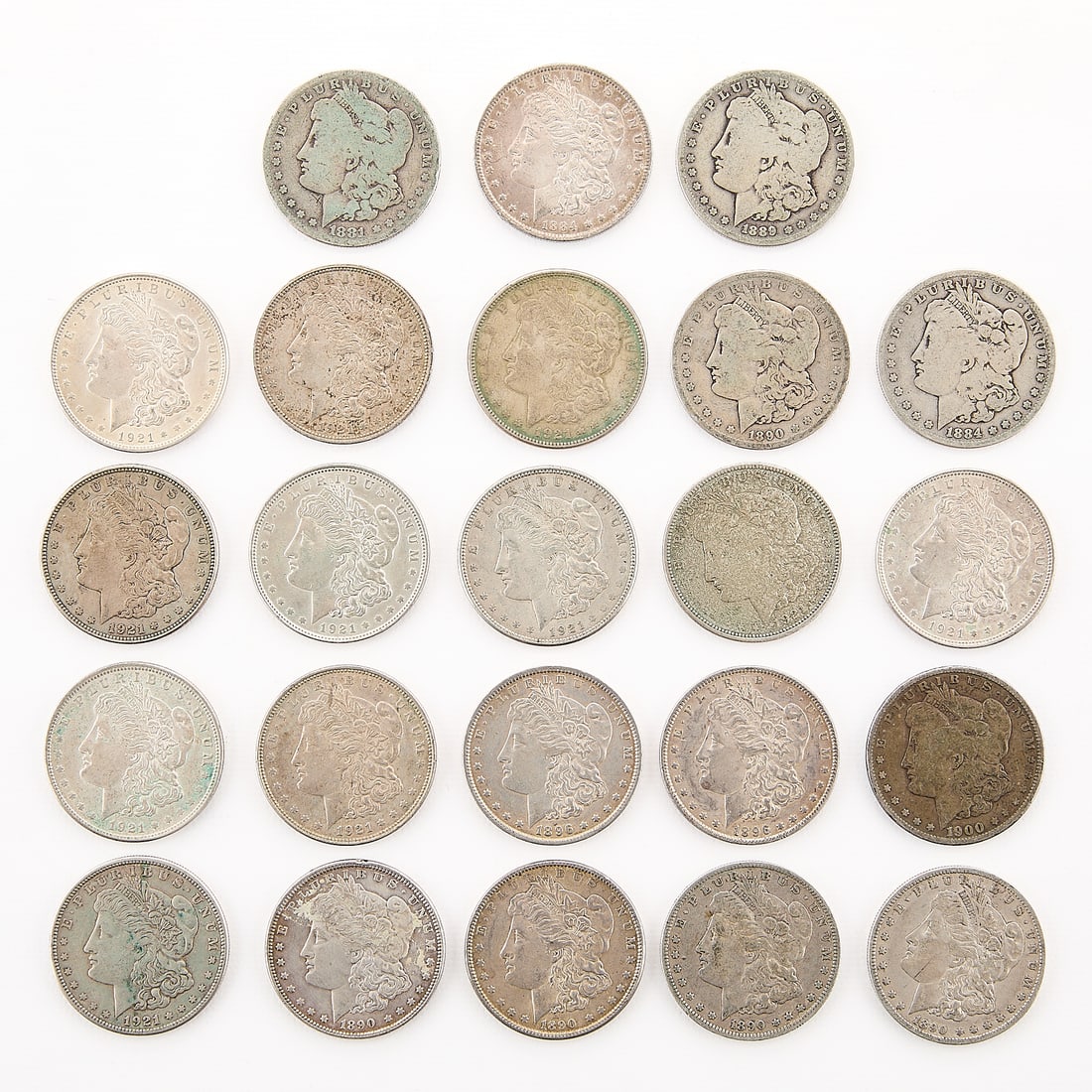 23 Morgan Silver Dollar Coins: Including the following coins: 1881-O, 1884, 1884-O, 1889-O, three 1890, two 1890-O, two 1896, 1900-O, seven 1921, two 1921-S, and two 1921-D. (Each, approx.) Diameter: 38.10 mm. Weight: 26.73 g.