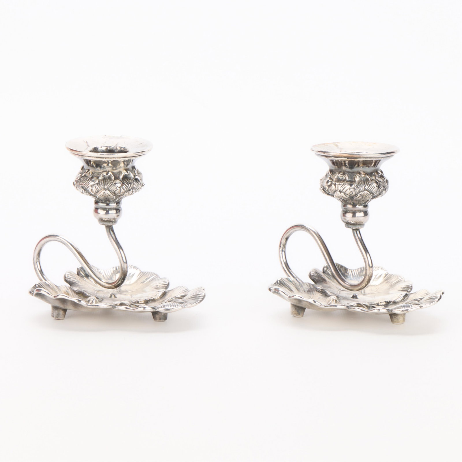 Pr Silverplate Lilypad Chambersticks: Pair of silverplate chambersticks or candle holders in the form of lily pads. Not marked. (Each) Height: 4 in x width: 3 3/4 in x depth: 5 in. Gross weight: 483.6 g.