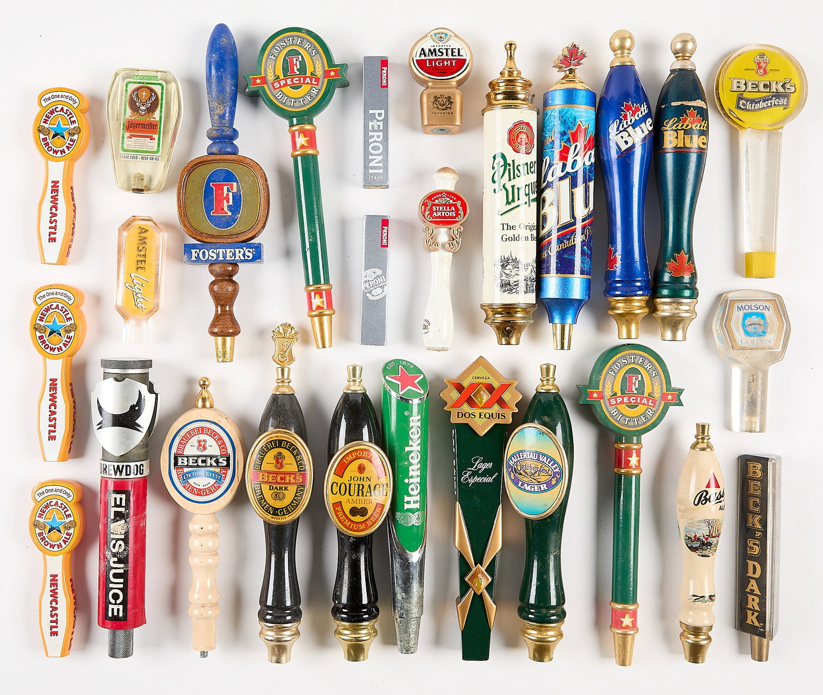 27 Assorted Imported Beer Taps: Group of 27 assorted importer beer taps. Including Becks, Peroni, Dos Equis, Heineken, Stella Artois, Foster's, Jagermeister, Newcastle, John Courage, Hallertau Valley, Molson, Bass, Labatt Blue,