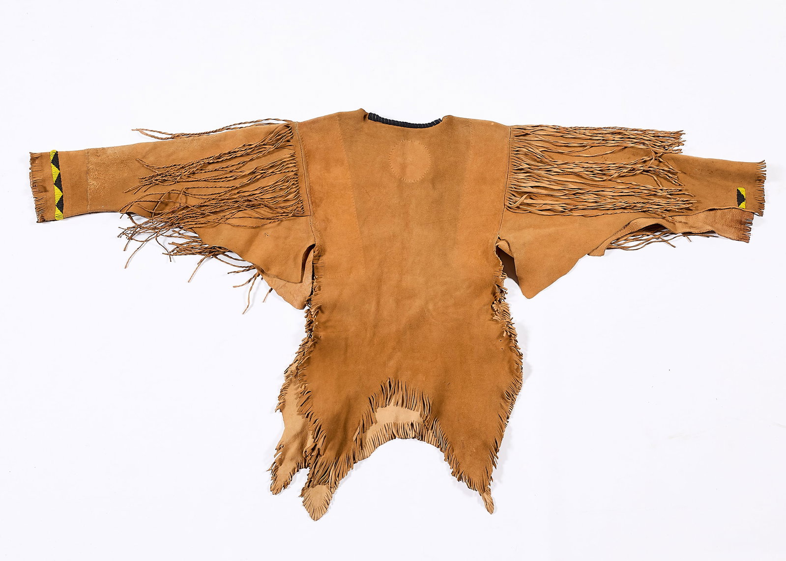 Western Style Fringed Buckskin & Beadwork Poncho: Native American or Western-style buckskin leather shirt or poncho. With decorative black and yellow beadwork along the cuffs and fringe along the arms, shoulders, and bottom hem. Length: 36 in x