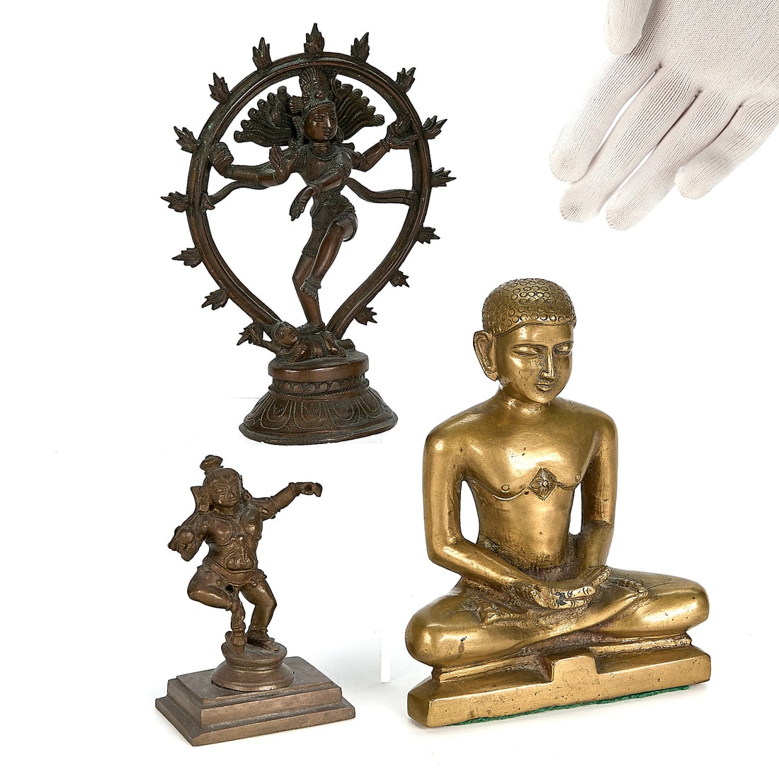 3 Indian Bronze & Brass Deity Figures: Group of three Indian bronze and brass figures depicting Hindu deities and seated buddha forms. Height ranges from 4 in to 6 1/2 in; width ranges from 2 3/4 in to 5 3/4 in; depth ranges from 1 1/2 in 