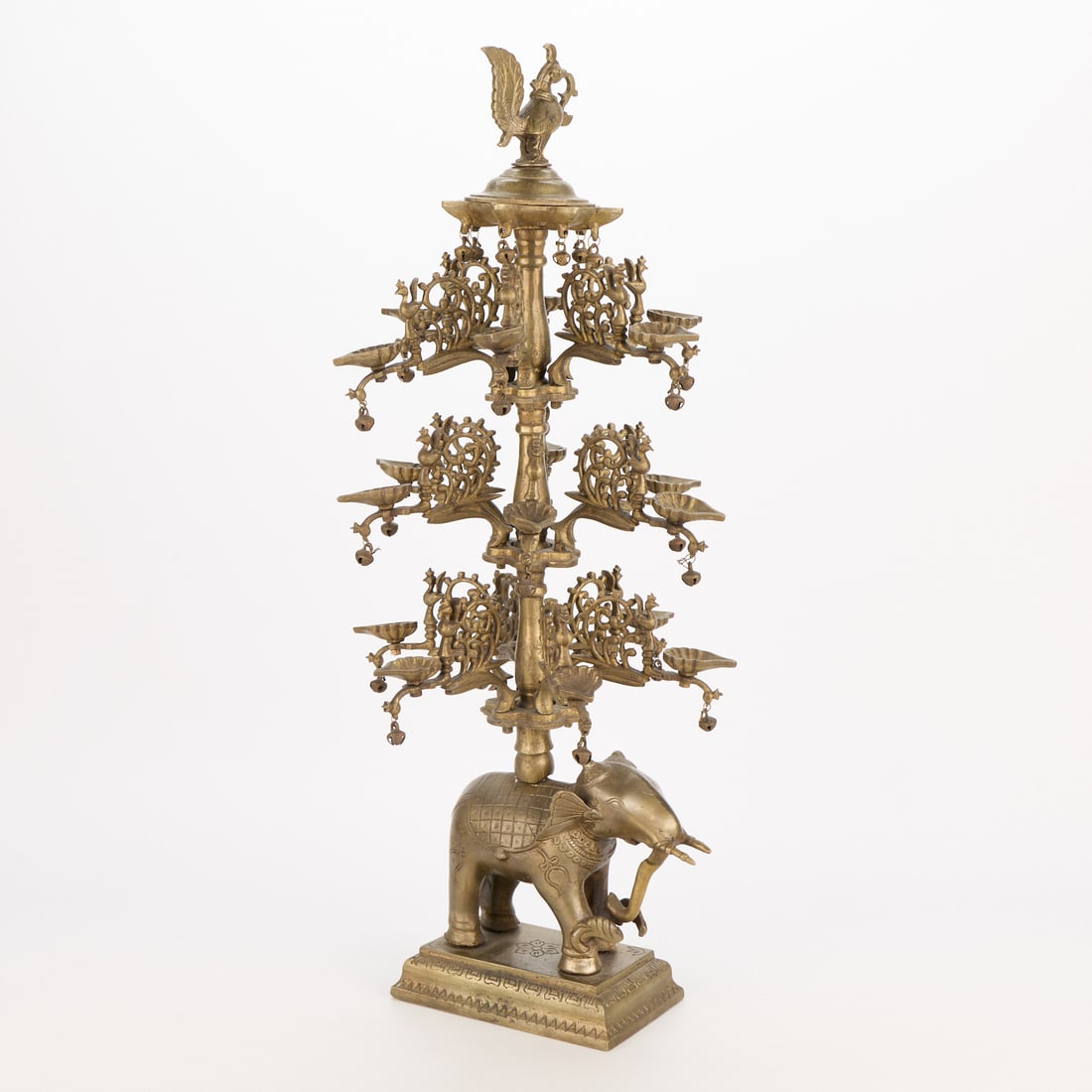 Lrg Indian Bronze Elephant Lamp 23 lb: Large Indian bronze diya 18-wick tiered elephant lamp. Depicting an elephant along the lowest tier and a bird motif along the top tier. Height: 27 1/4 in x width: 11 1/2 in x depth: 12 in. Weight: 23 