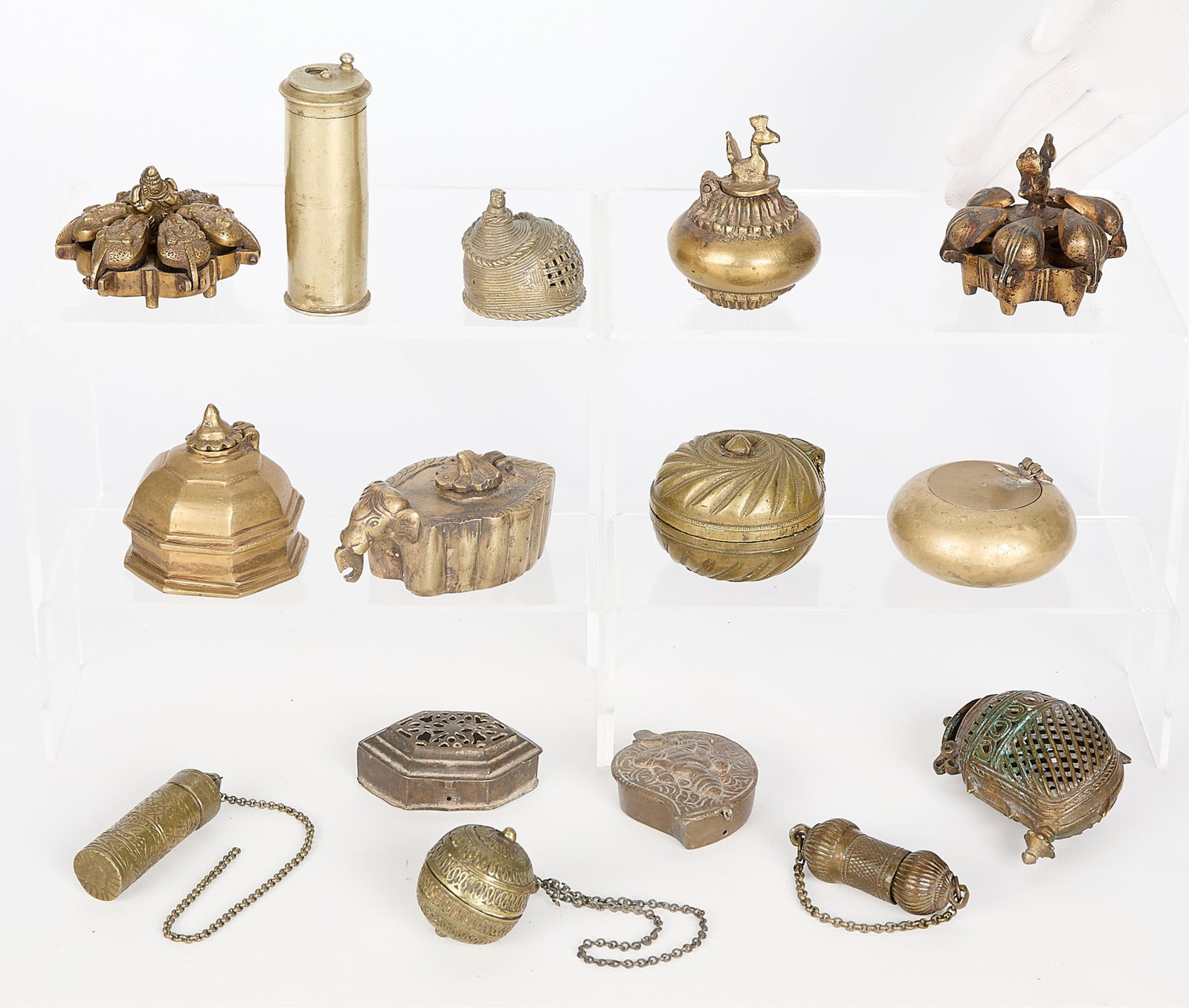 15 Mini S. Indian Bronze & Brass Boxes & Vessels: Group of 15 miniature South Indian brass and bronze boxes and vessels. Height ranges from 1/2 in to 3 3/4 in; width ranges from 1 in to 3 in; depth ranges from 1 in to 3 in. Gross weight: 4 lbs 10 oz.