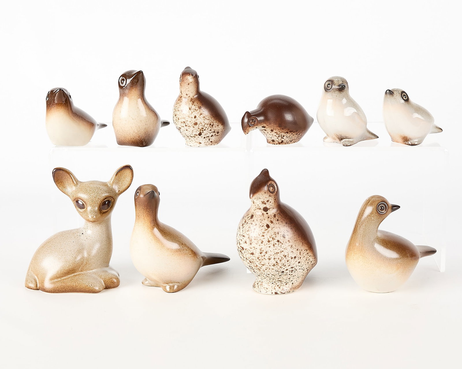 10 Howard Pierce Art Pottery Animal Figures: Group of 10 Howard Pierce art pottery ceramic animal figurines. Including three quail, two small brown brids, two small white birds, a deer or doe, and two pigeons. Five with ink-stamped maker's mark.