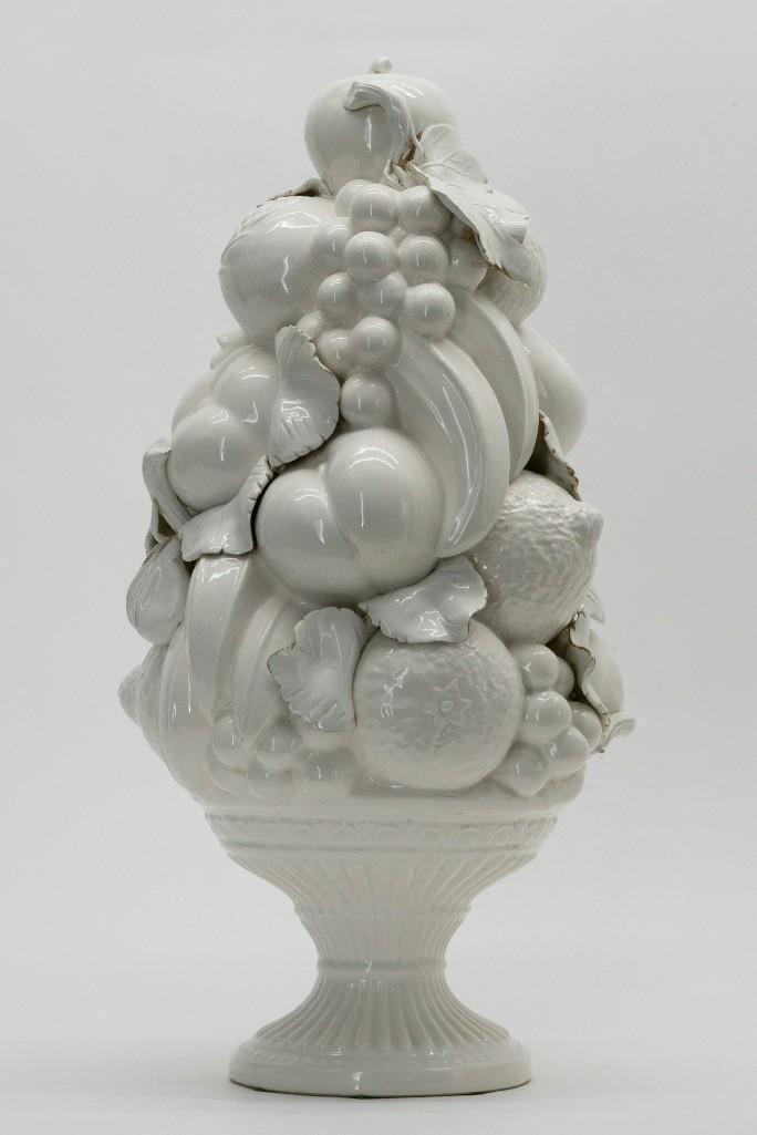 Italian Porcelain Fruit Tower Majolica Centerpiece: This vintage white glazed Italian Majolica centerpiece features a pedestal bowl supporting a tower of various fruits including grapes, apples, bananas, citrus and peaches. Stamped Made in Italy on the