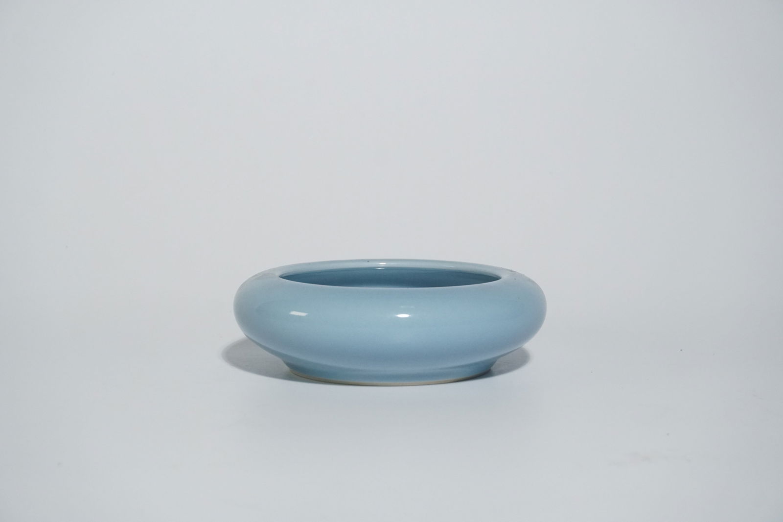 An antique Chinese porcelain water: An antique Chinese porcelain water coup glazed in a baby blue hued glaze. The bottom of the coup contains an inscription reading: Da Qing Guanxu Nianxin or Produced During the Reign of Emperor Guangxu