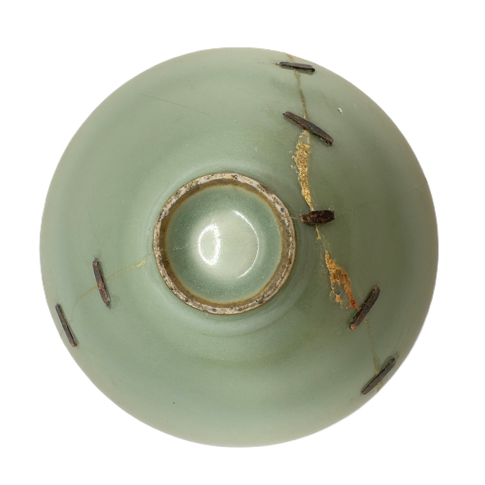 A Chinese Kintsugi Repaired Celadon Bowl Base: The underside of an antique Chinese celadon glazed bowl, showing visible evidence of traditional Kintsugi repair, where gold lacquer has been used to mend cracks, highlighting its history and value. D