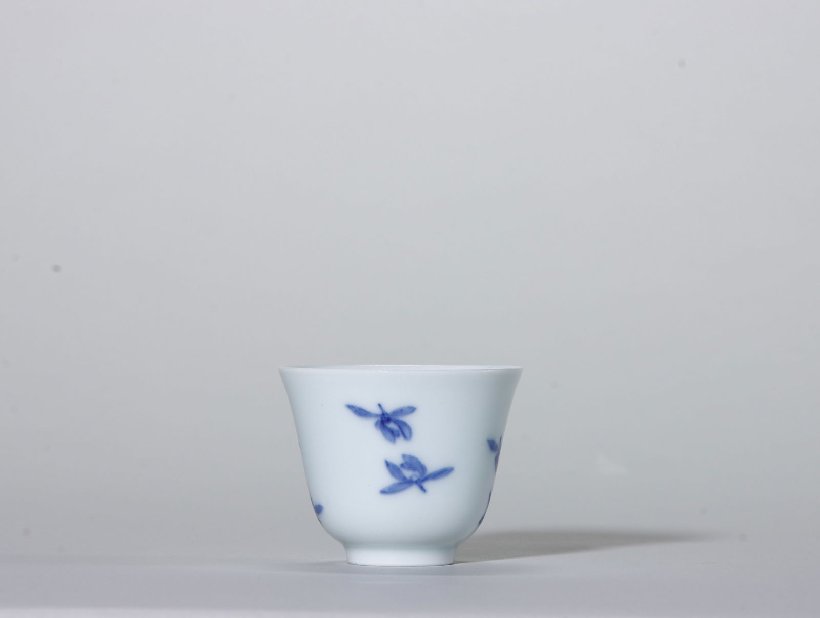 A Chinese Blue and White Floral Cup.19th.C: This delicate porcelain cup dates to the Guangxu reign (1875–1908) of the late Qing Dynasty, showcasing the enduring elegance of underglaze blue porcelain. The cup is adorned with a pattern of scatt