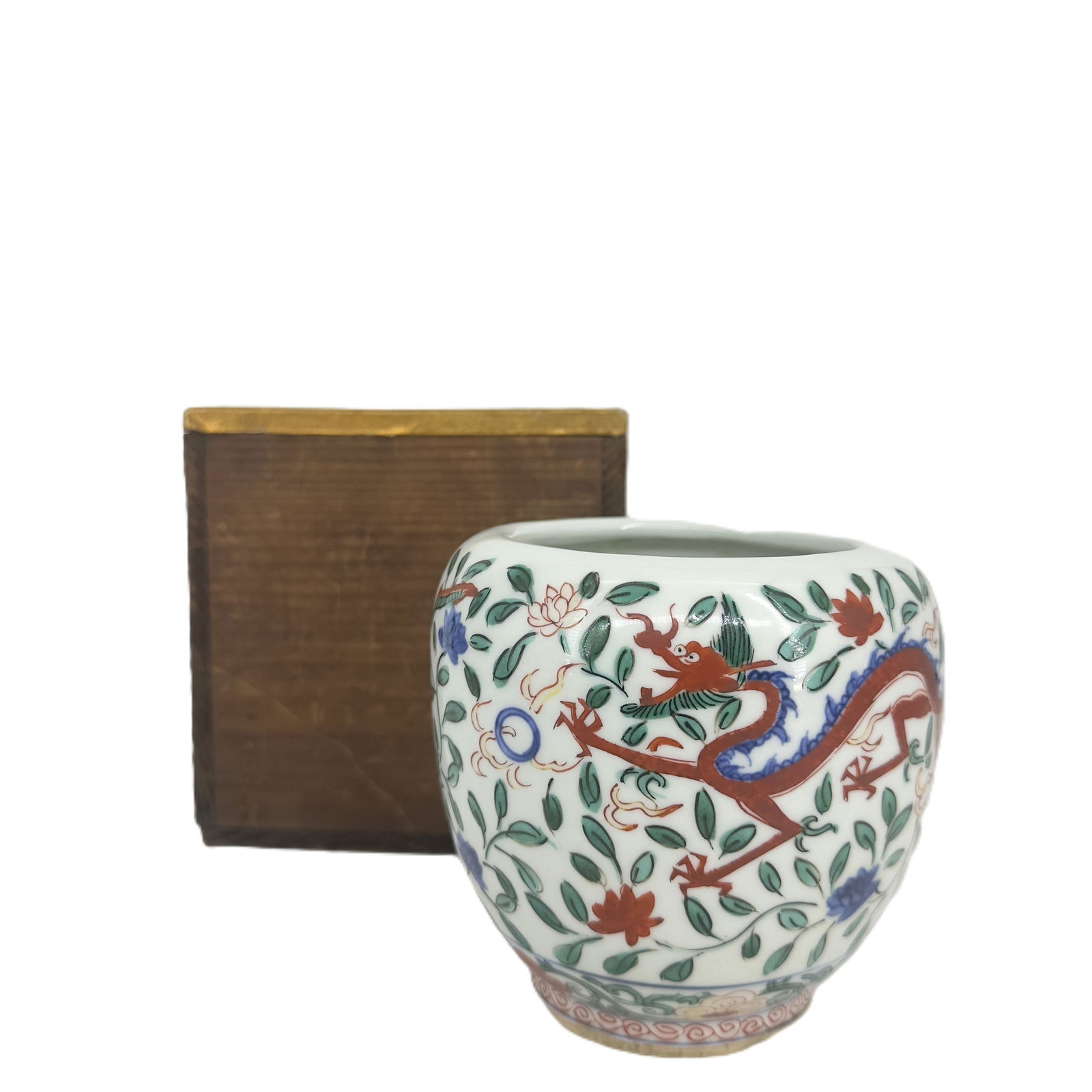 Famille Verte or Wucai Porcelain Jar with Dragon: A vibrant porcelain jar or planter, decorated in rich Famille Verte or Wucai enamels. It features a bold red and green dragon amidst swirling clouds and floral motifs, often associated with imperial a