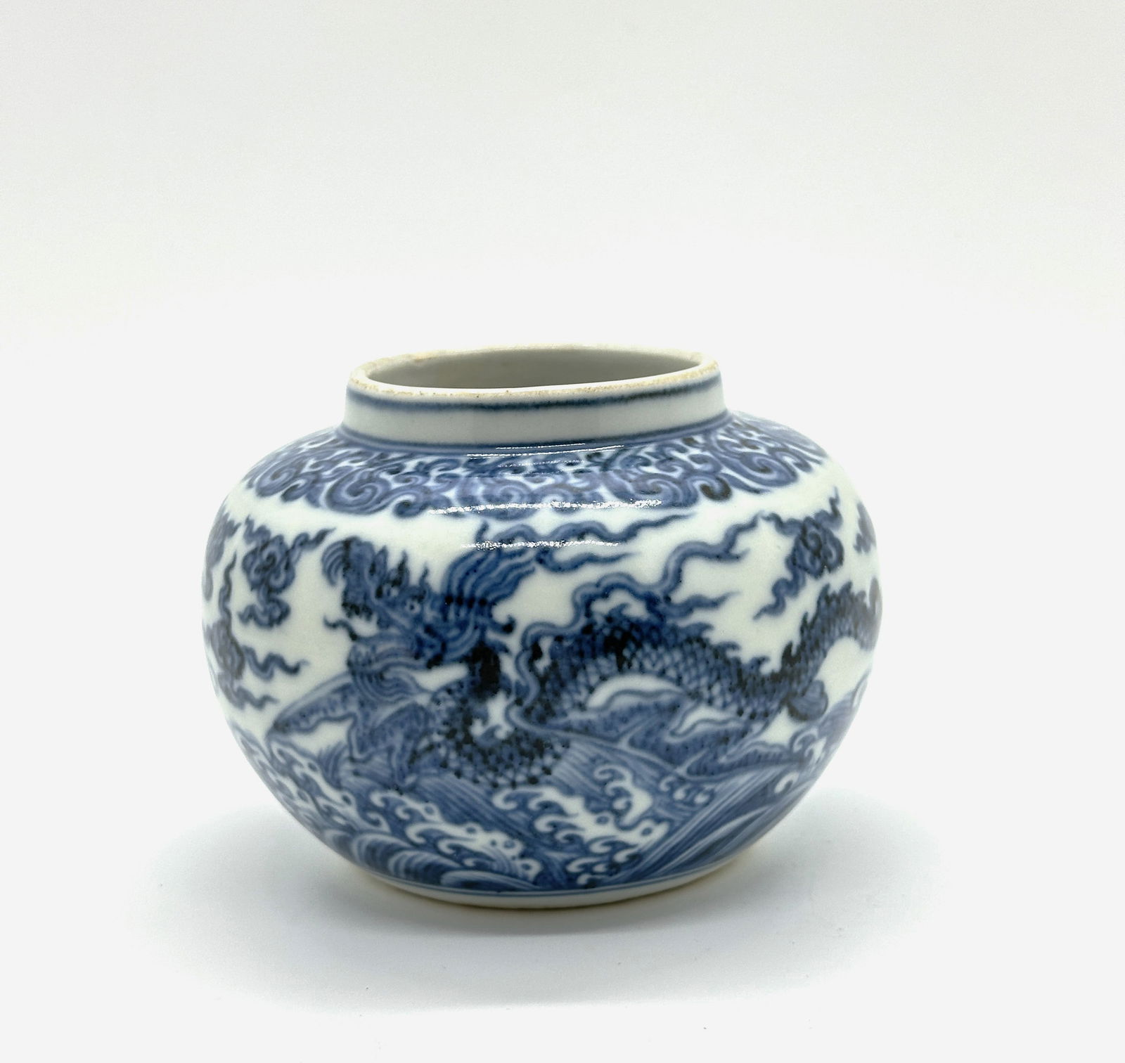 CHINESE BLUE WHITE DRAGON PORCELAIN JAR,19/20th.C: This globular jar, a 19th or 20th-century reproduction, is decorated with a powerful five-clawed dragon amidst clouds and waves in deep underglaze blue. It reflects the enduring admiration for Ming