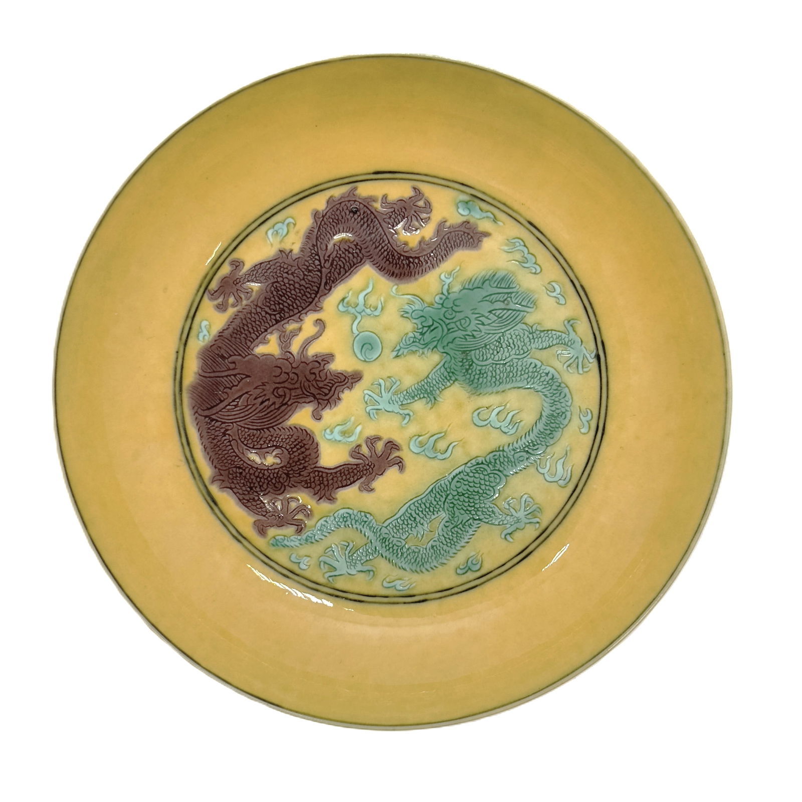 A Chinese yellow porcelain plate with a “dragon?? pattern. 19th. (1 of 2)