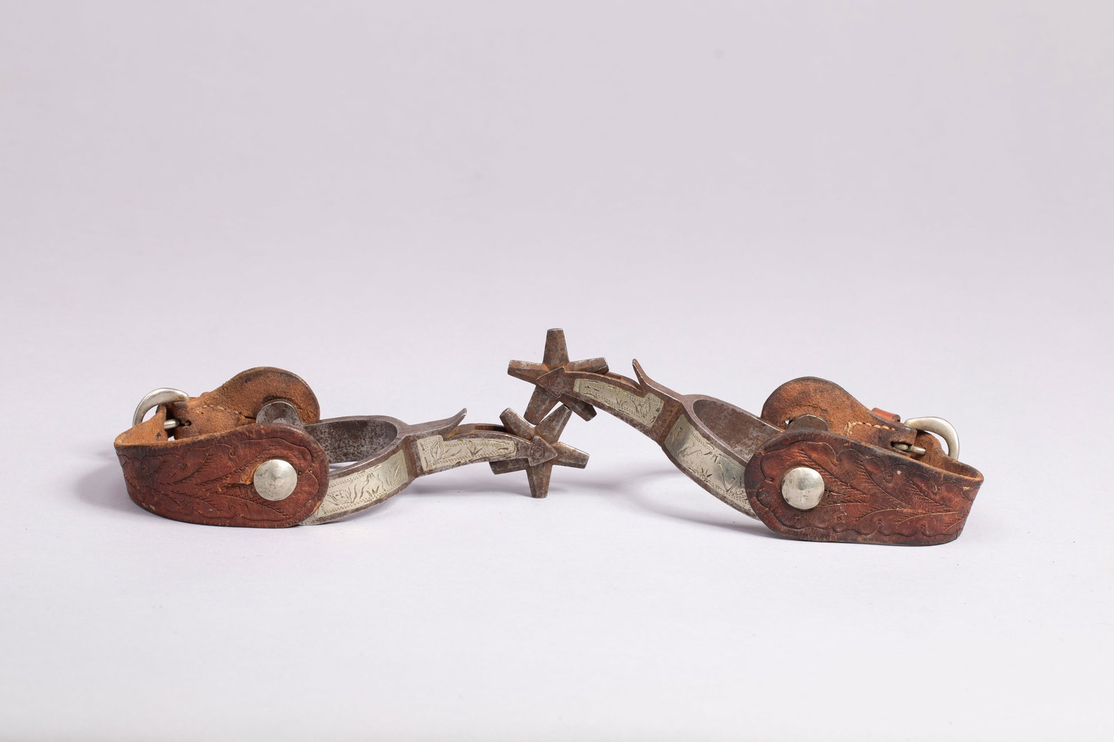 Silver Inlaid Arrowhead Canon City Prison Spurs: Canon City Prison spurs with silver inlaid arrow shank and five-point hand filled rowels. Classic Canon City period design and styling, fitted with fine period straps. Ca. 1930-1940