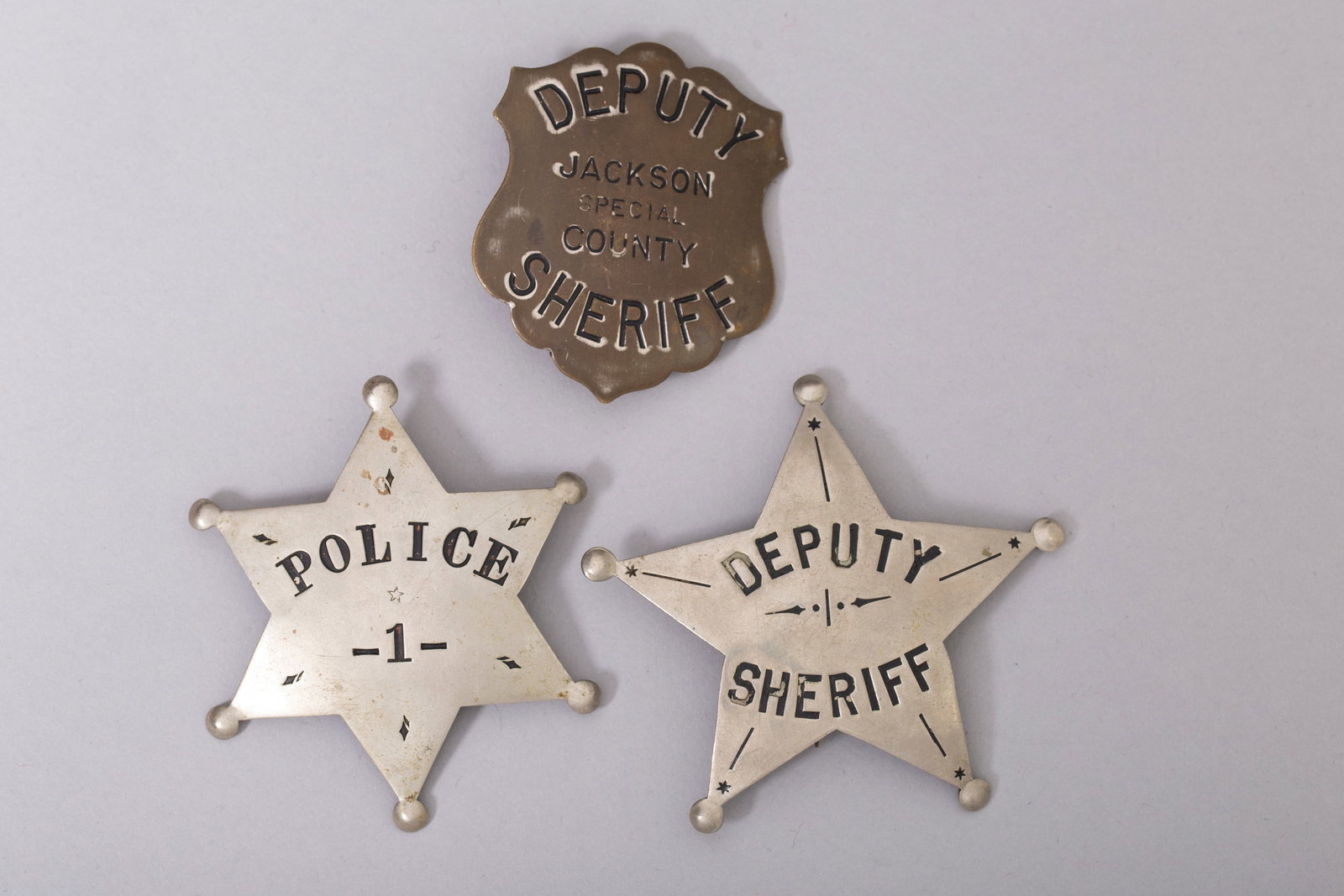 Lot of 3, Authentic Vintage Sheriff Deputy Badges: 1. Marked "POLICE -1-" front, "WAND" back, 2 1/2"H x 2 1/4"W 2. Marked "DEPUTY SHERIFF", 2 3/4"H x 2 1/2"W3. Marked "DEPUTY JACKSON SPECIAL SHERIFF" front, "ART BURNSIDE, POLICE EQUIPMENT, SPOKANE, WA