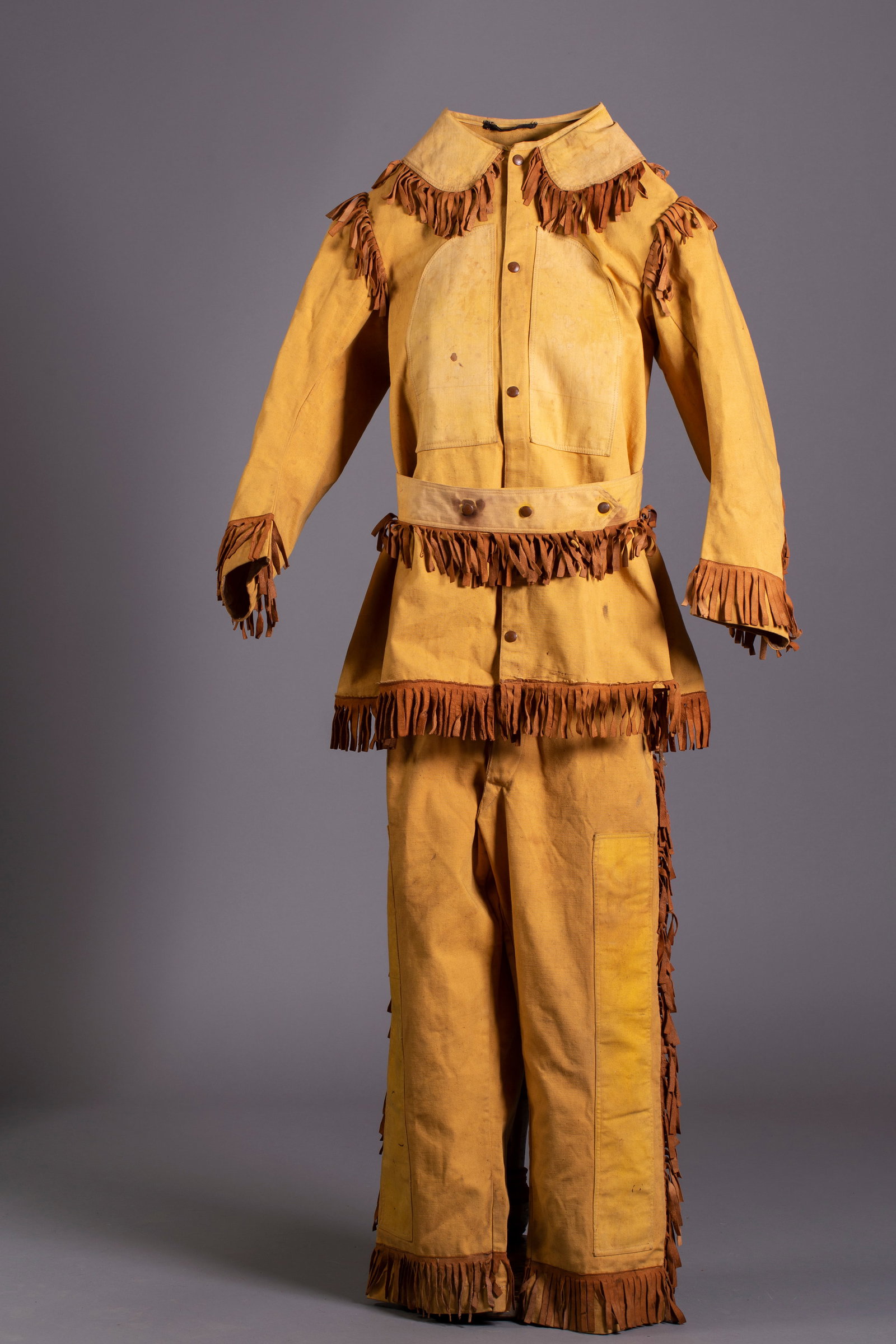 Vintage Wild West Show Outfit: Vintage Wild West Show Outfit. Tan canvas jacket with brown suede fringe, canvas tan pants with suspenders and brown suede fringe.