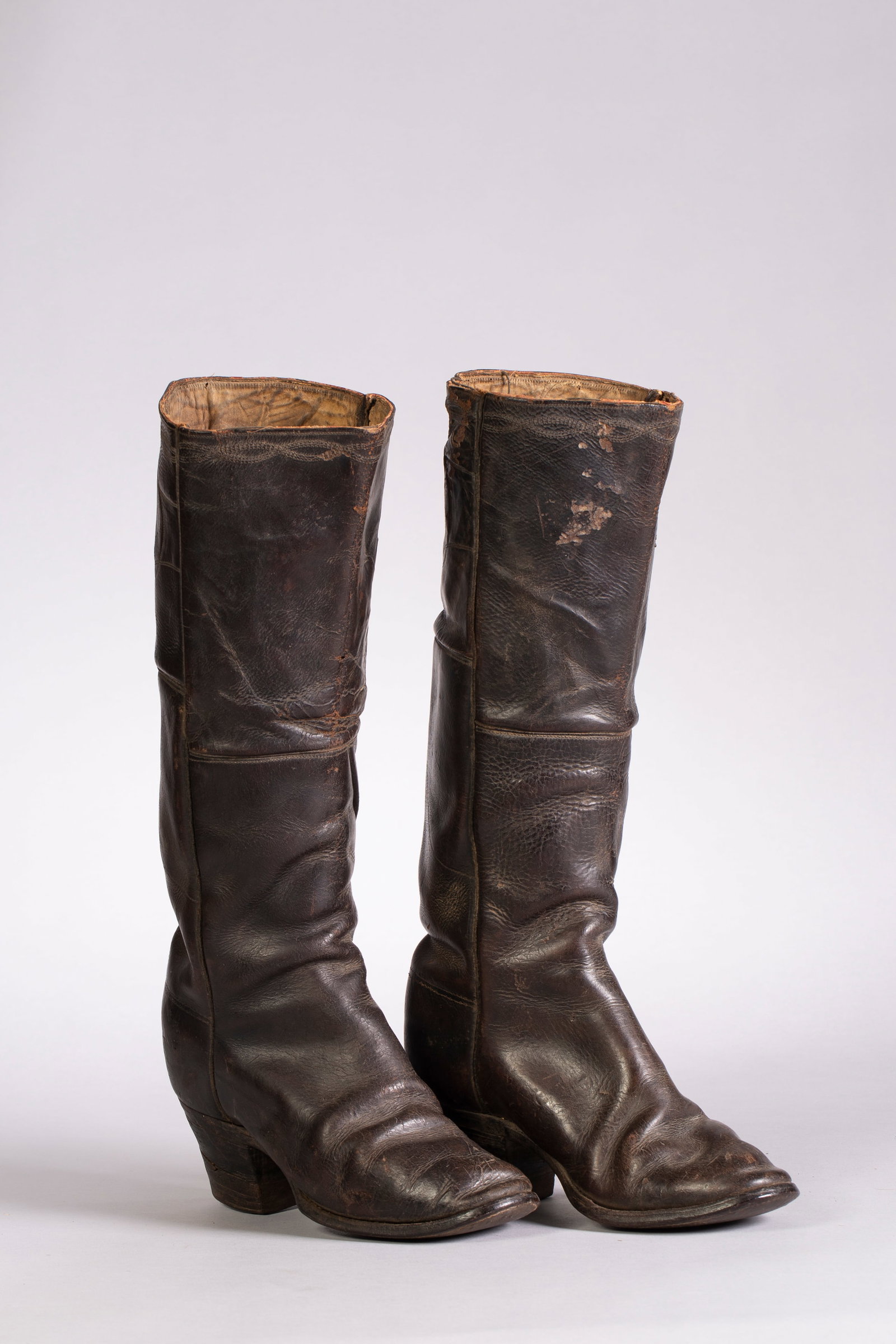 Vintage Tall Cowboy Boots, Ca. 1890s: Vintage Tall Dark Brown Cowboy Boots, Ca. 1890s. Made of leather with canvas pull up straps. Shows age-appropriate wear. Measurements: 9 1/2"L, 17 1/2"H