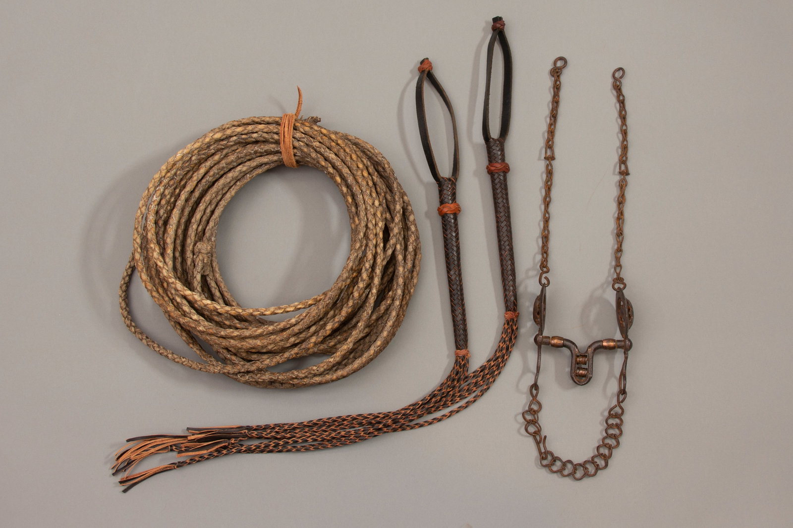 Lot of 4, Lariat, Mexican Bit: Early sunflower Mexican bit, two black and brown leather braided quirts, Lariat length: 65 feet