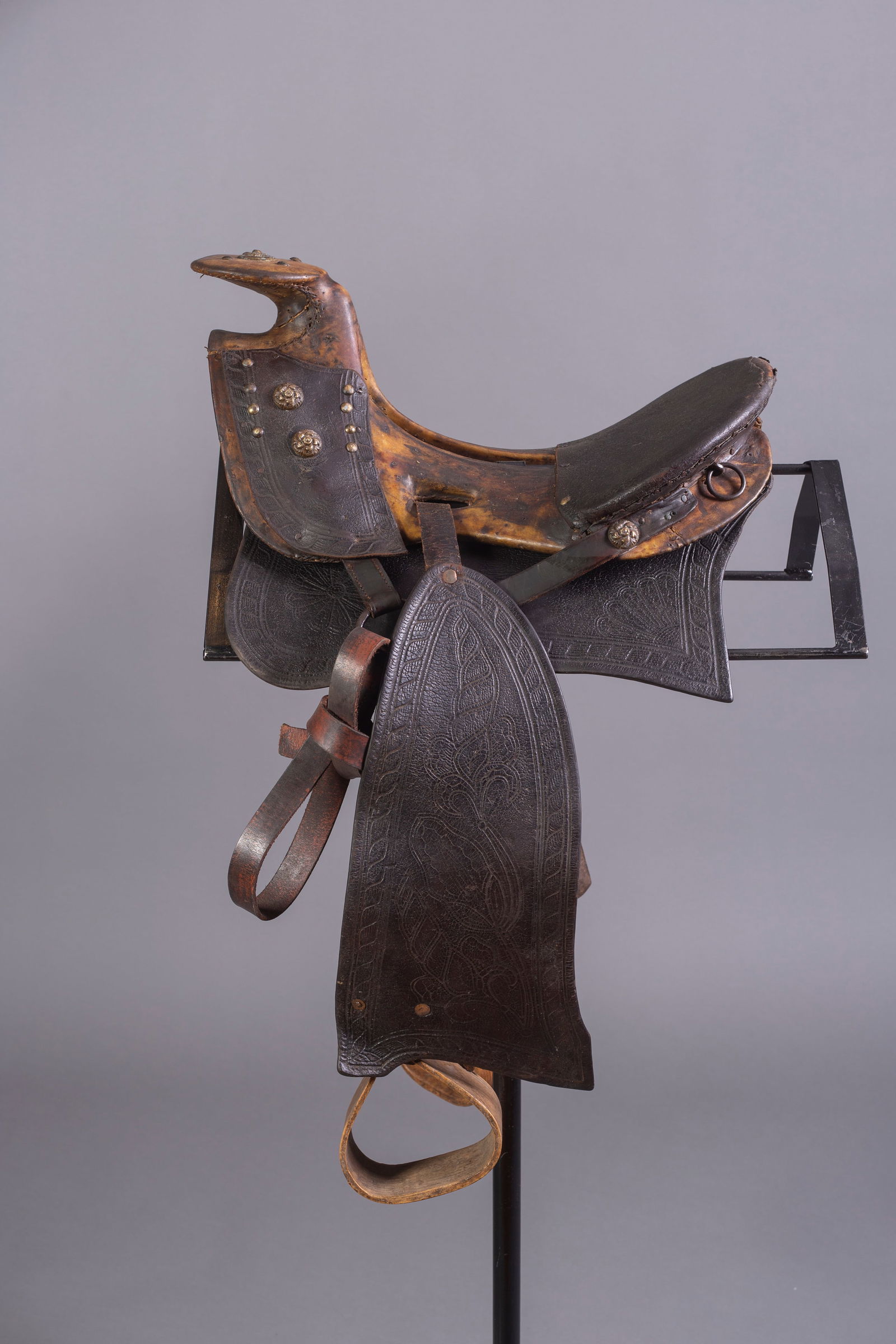 Texas Hope Style Saddle, 19th Century: Texas Hope Style Saddle, 19th century, built on wood tree with 2 conchos on each side and tacks with concho on horn, tooled fenders with wooden stirrups, tacks on horn, 13 1/2" seat. Please note, stan