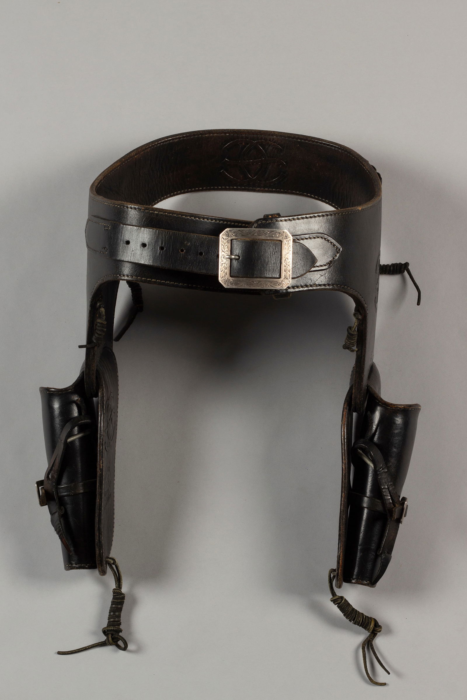 Vintage Bohlin Black Leather Double Quick Draw Rig: Vintage "Edward H. Bohlin, Hollywood Cal," marked black leather double Quick Draw Rig made for a pair of 4 3/4" revolvers. Rig has engraved sterling buckles marked "Bohlin" four times. Matching hand e