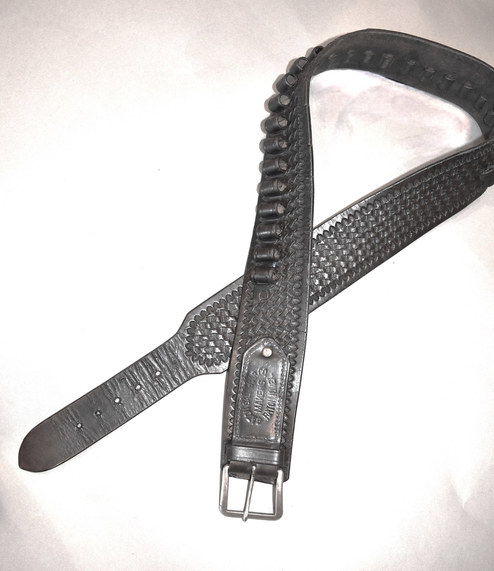 Attention New Mexico Western Collectors: New Mexico Marked Cartridge Belt: Vintage black tapered leather gun belt marked "RATON SAD. & HAR. CO., RATON. N. MEX." with a basket weave design. Measurements 43"L x 2"W Good Condition. Provenance: New Mexico collector