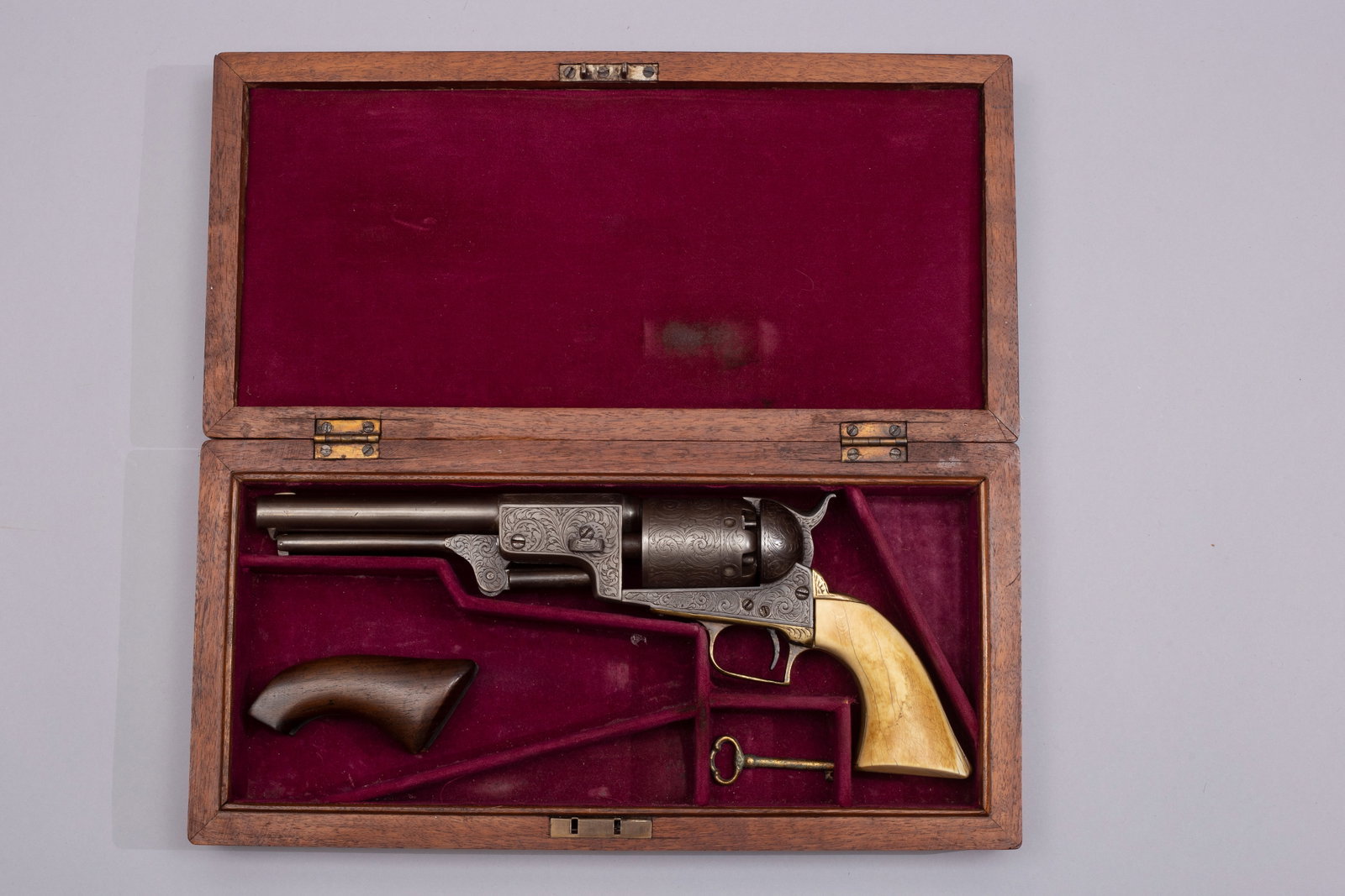 Antique Colt Engraved First Model Dragoon, Ca. 1849: Six shot revolver, .44 caliber, serial number 4668, German silver blade front sight, and hammer notch rear. Near full coverage engraved in typically seen New York style, with arabesque foliate and flo