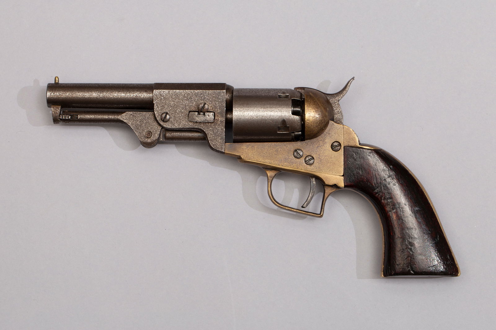 Reproduction Colt Model 1849 Pocket Revolver with Walnut Grips: Antique reproduction Colt 1849 black powder revolver with walnut grips, brass frame with square back trigger guard. Marked "T&A Natchez" on top of barrel. Marked "U.H. 2nd Tex ca", .31 caliber, Serial