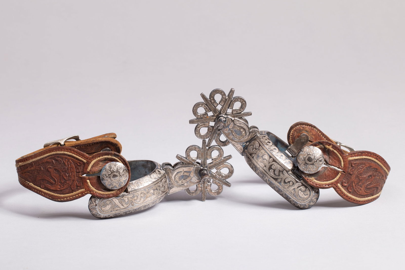 Mexican Charro Spurs with Horseshoe Rowel Pin: Beautiful silver inlay with 6 point rowel and rare horseshoe rowel pin, nice leather tooled straps. Heel band opening 3", Rowel diameter 2 1/2"