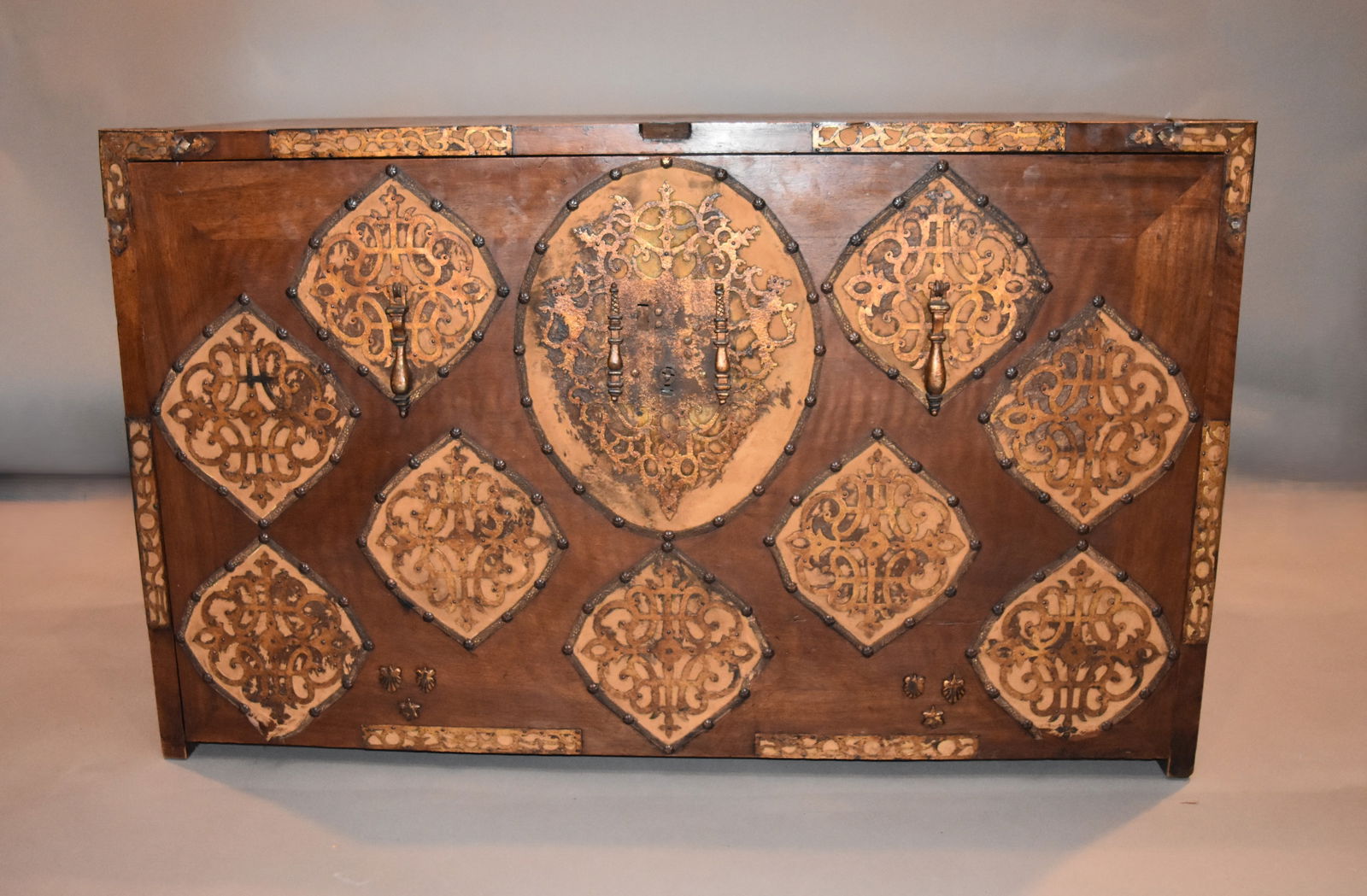 Spanish Colonial Vargueno Desk: Vargueño, Spain, Ca. 19th Century, Wood with brass cast conch decorative details on the front, sides and interior drawer pulls. Drawers are fitted with interior removable velveteen beds for silverwar