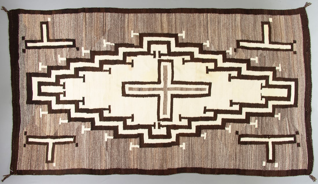 Klagetoh Navajo Rug, Ca. 1910: Wonderful antique floor rug most likely from the Klagetoh area of the Navajo Nation, Ca. 1910. The rug has a full field concentric stepped medallion with a central cross on a beautiful hand carded, hi