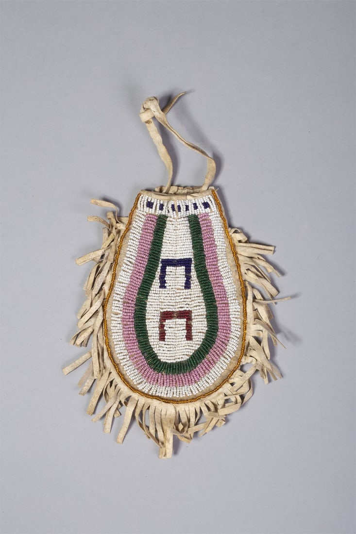 Santee Sioux Pony Track Beaded Bag: Pony Track Beaded bag on tanned hide, with white, pink and green beaded rows with navy and red pony track design, outlined in fringe. Measurements: 7"L x 5"W