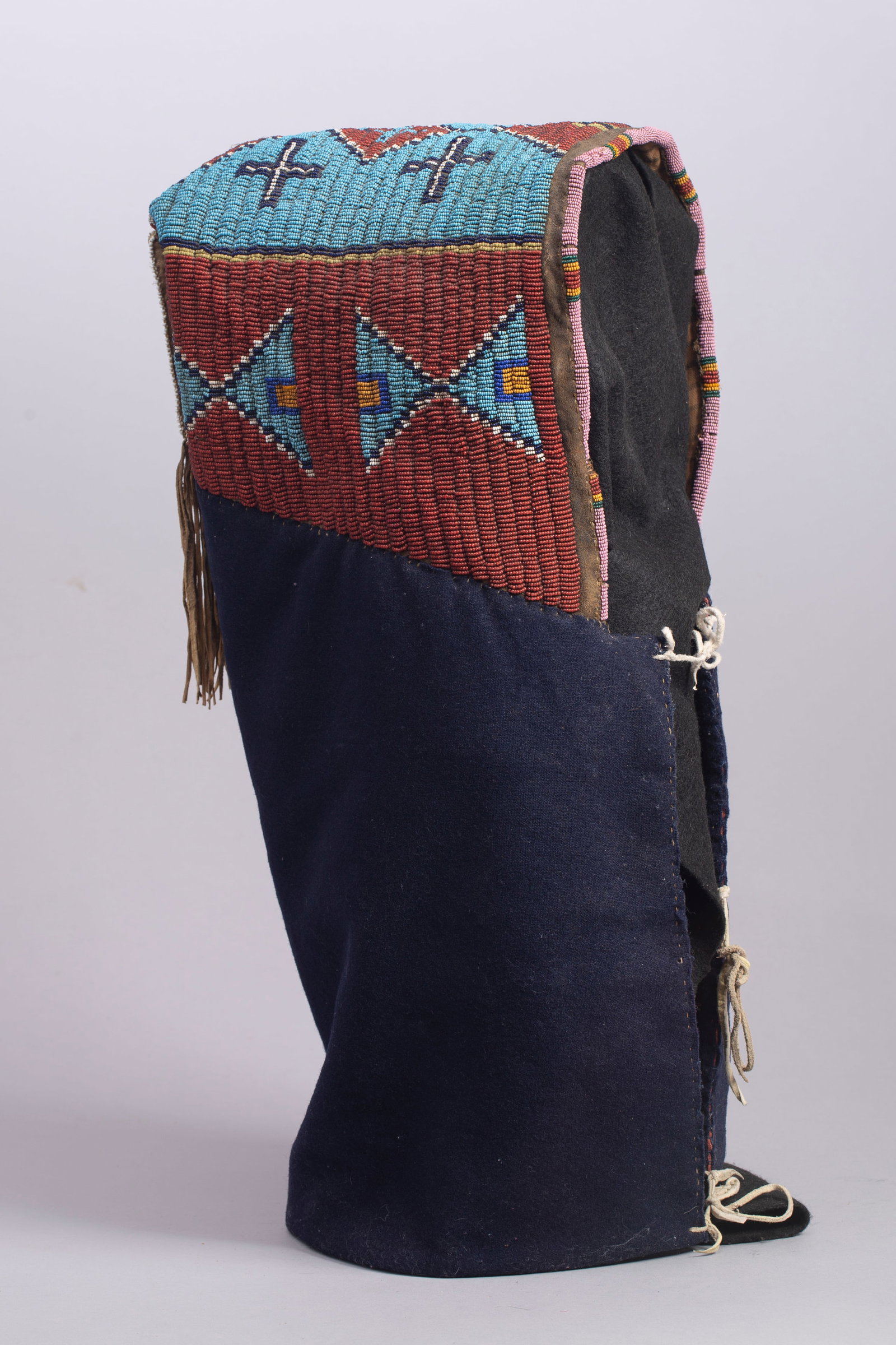 Arapaho/Sioux Soft Cradle with Custom Stand, Ca. 4th Quarter of 19th Century: Arapaho/Sioux Soft Cradle with Custom Stand, Ca. 4th Quarter of 19th Century. Soft cradle is beaded on top with light blue background and white heart red, dark blue, white, yellow, and light blue geom