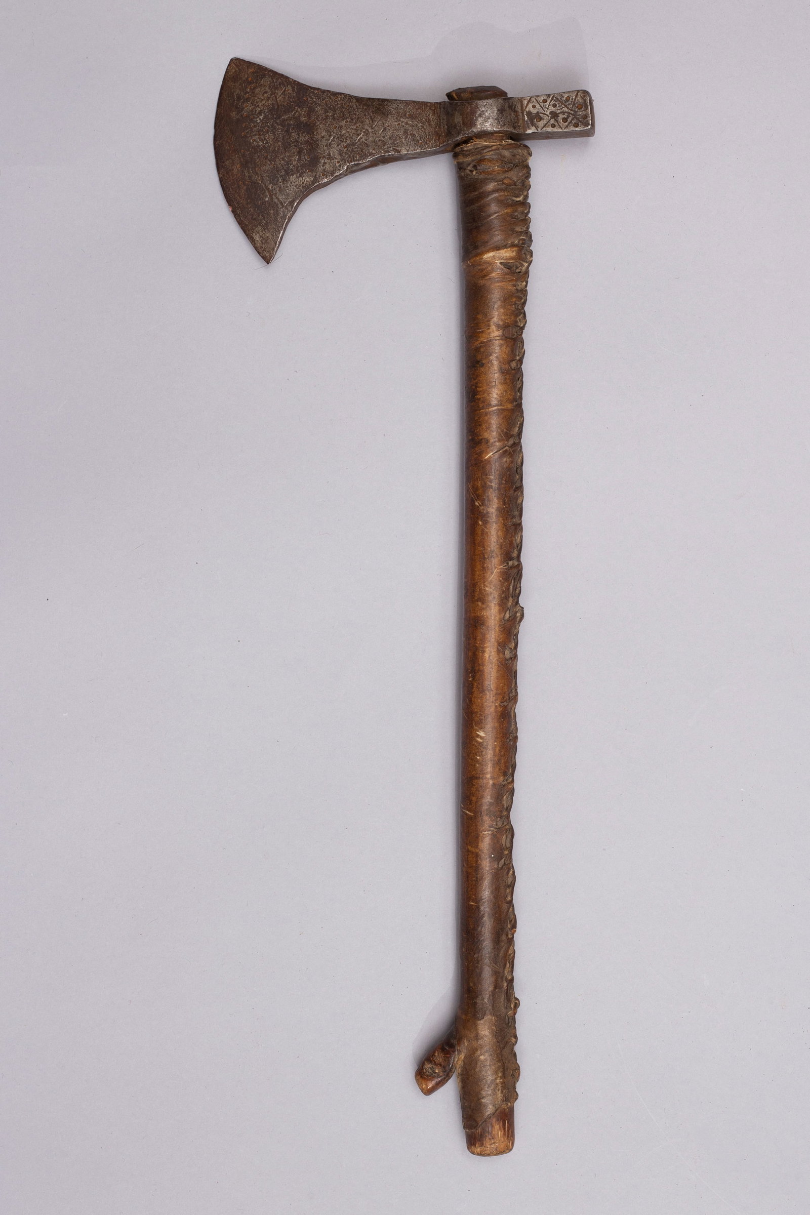 Early Native American "Squaw" Camp Axe: Early Forged axe head with solid wood haft wrapped in rawhide. Axe head has native markings.Haft: 16", Axe head: 6"