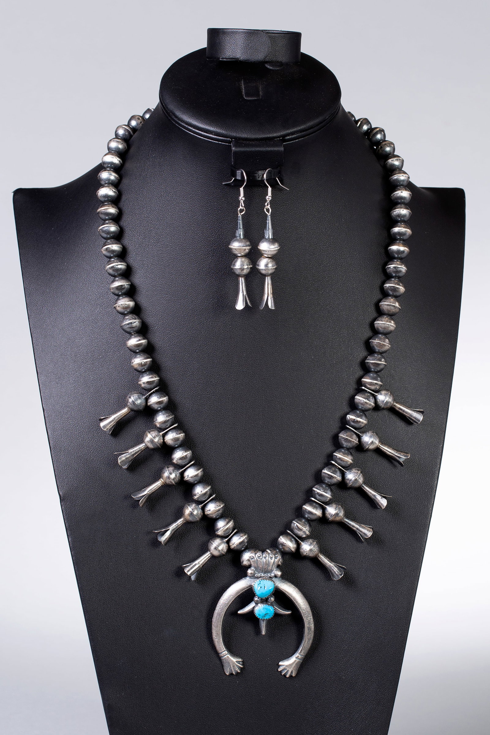 Squash Blossom Necklace with Sterling Beads & Turquoise on Naja with Squash Blossom Earrings: Vintage squash blossom necklace with 10 squashes. Two turquoise stones on the Naja. Necklace Length: 24 1/2", Naja: 2" x 2", Earring Length: 2 1/2", Weight: 110 grams