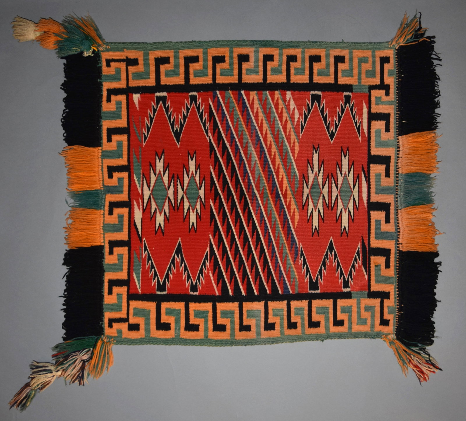 Germantown Fancy Sunday Saddle Blanket with Fringe, Ca. 1890: Navajo Germantown saddle blanket, Measurements: 29 1/2" x 24", Ca. 1890