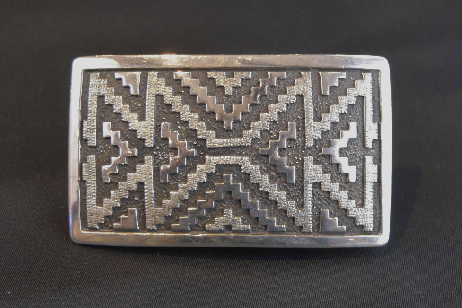 Navajo Rug Pattern Belt Buckle by Dan Jackson: By award-winning Navaho artist Dan Jackson, whose mother was Bernice Charlie, a fine weaver who inspired his design. (See also matching bracelet and bolo tie.) Buckle: 3" W, 1 3/4" H, 49 grams