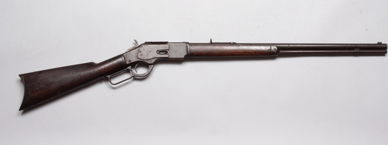 Antique Winchester Model 1873 Rifle: Third model, Made in 1883 with Serial number 150229, .32 caliber. Desirable globe front site. Mostly grey-brown patina, Scattered pitting/oxidation.