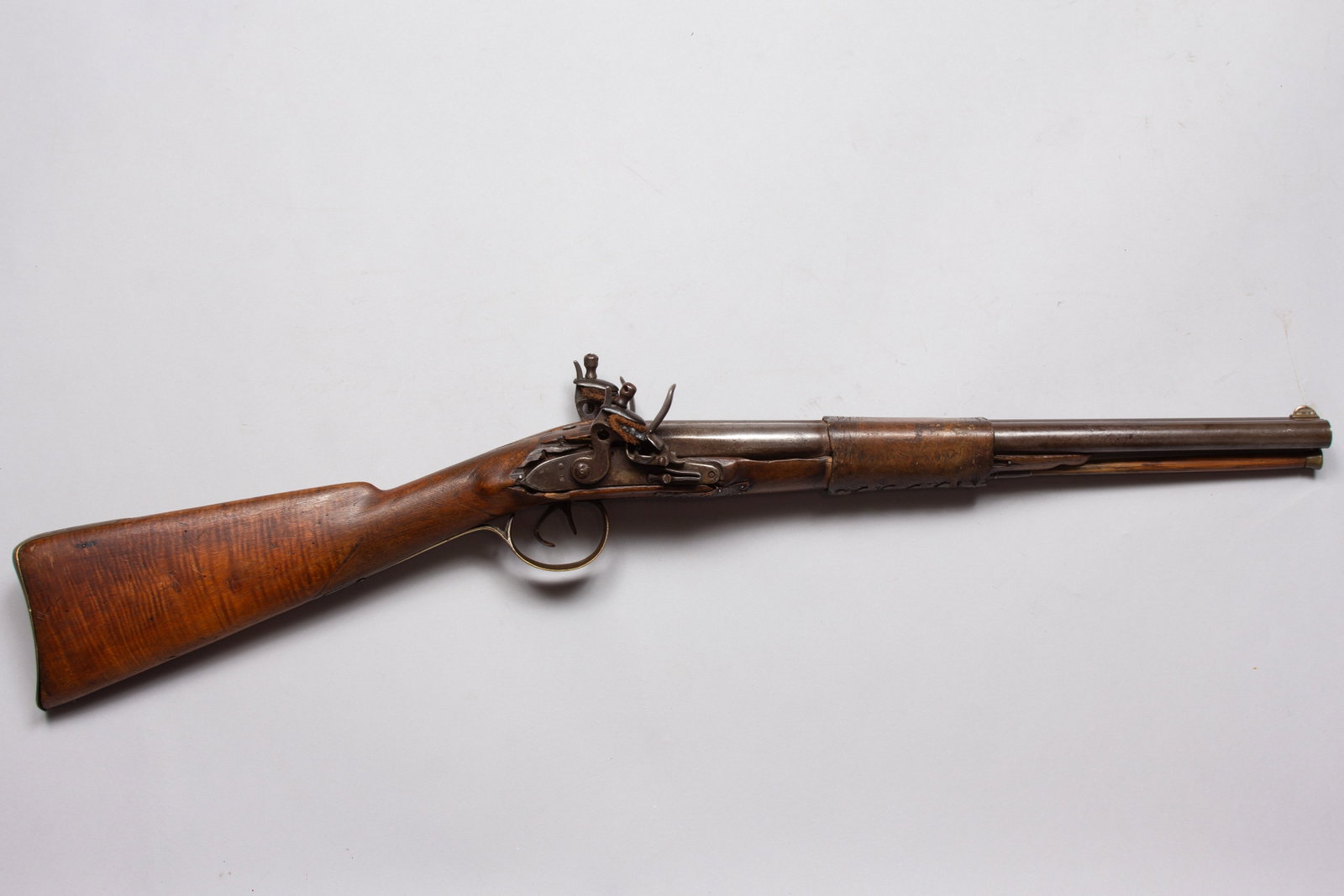 Historically Significant Double Barreled Flintlock Indian Shotgun with Sioux markings: Antique, double barreled shotgun with 18” barrels. A true Indian gun with hide wrap and markings, Wendell Grangaard (President – The Guns of History, Inc.) examination of Togia markings indica