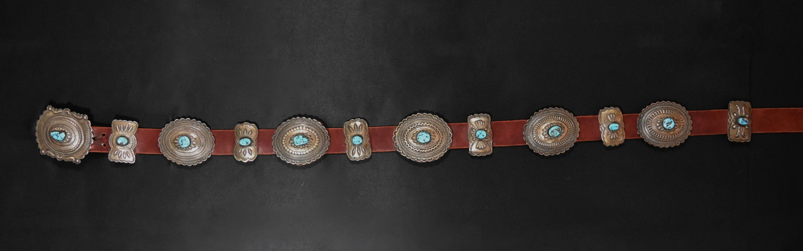 Sterling Silver & Turquoise Concho on Leather Belt, 6 Butterfly Conchos, 5 Oval Conchos, and Concho: 61 1/4" Length, Buckle: 2 3/4 x 3 1/4", Butterfly Conchos: 2 1/4 x 1 1/4", Oval Conchos: 3 x 2 1/2". 536 grams