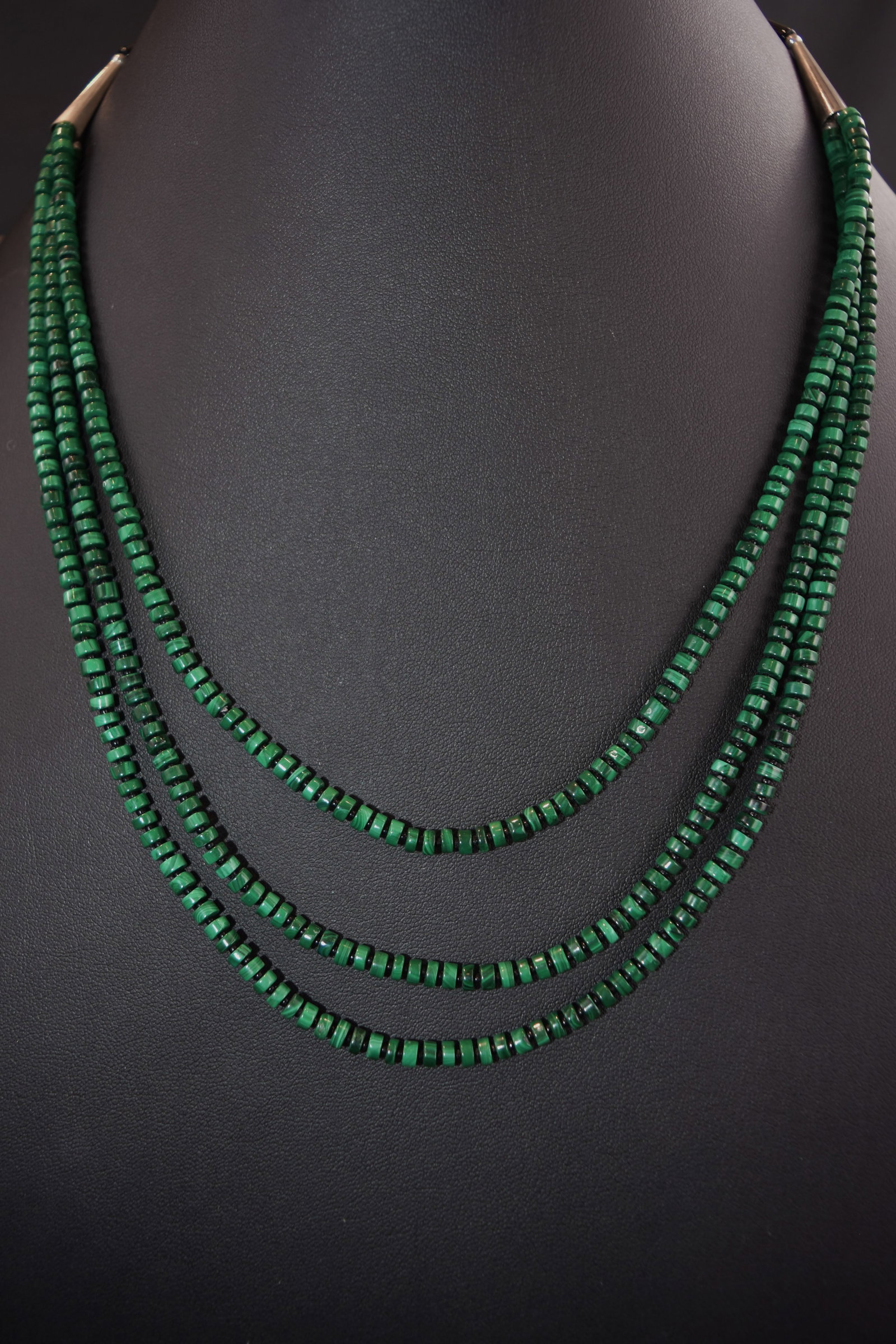 Heishi Three-Strand Malachite Necklace: Santa Domingo, Malachite beads are ¼” in diameter, separated with tiny black beads. Necklace: 24 1/2" Length, 45 grams