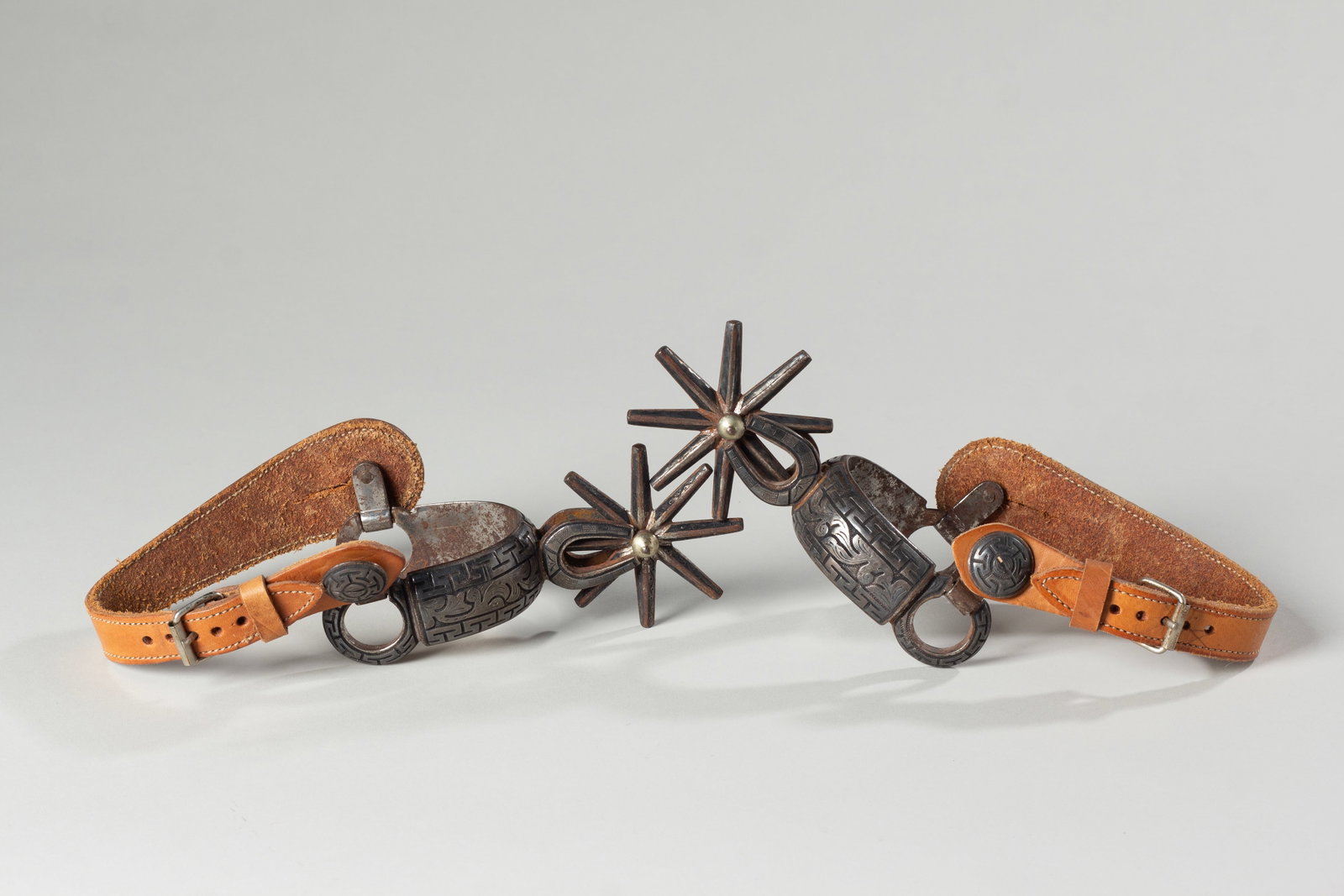 Mexican Spurs with horseshoe shank: Mexican Charro spurs Silver overlay with horseshoe shanks. 8 point rowel, 3 1/4" diameter rowel, heel opening 2 3/4" with leather straps