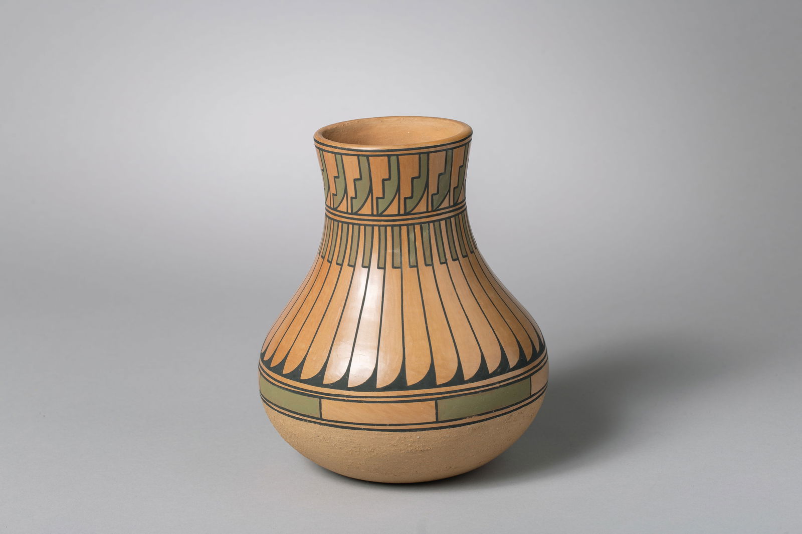 San Ildefonso Polished Natural Clay Jar, Blue Corn (1921-1999): San Ildefonso stone polished natural clay jar, Crucita Calabaza AKA: Blue Corn (12/7/1921-5/3/1999), Painted designs of black and green slips, lower part of vessel is slipped in beige micaceous clay;