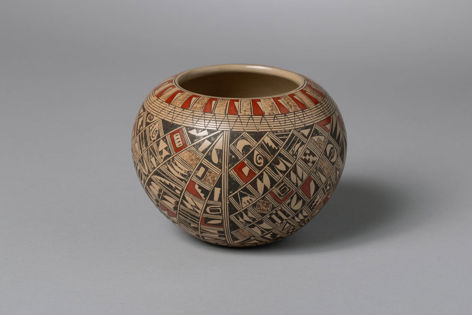 Hopi Tewa Polychrome Pot, Rondina Huma (b. 1948): Hopi Tewa Polychrome Pot, Rondina Huma (b. 1948), Many small geometrical designs3.75"H, 5"D; Provenance: The Common Ground, New York City NY, Present: Korte Family Collection