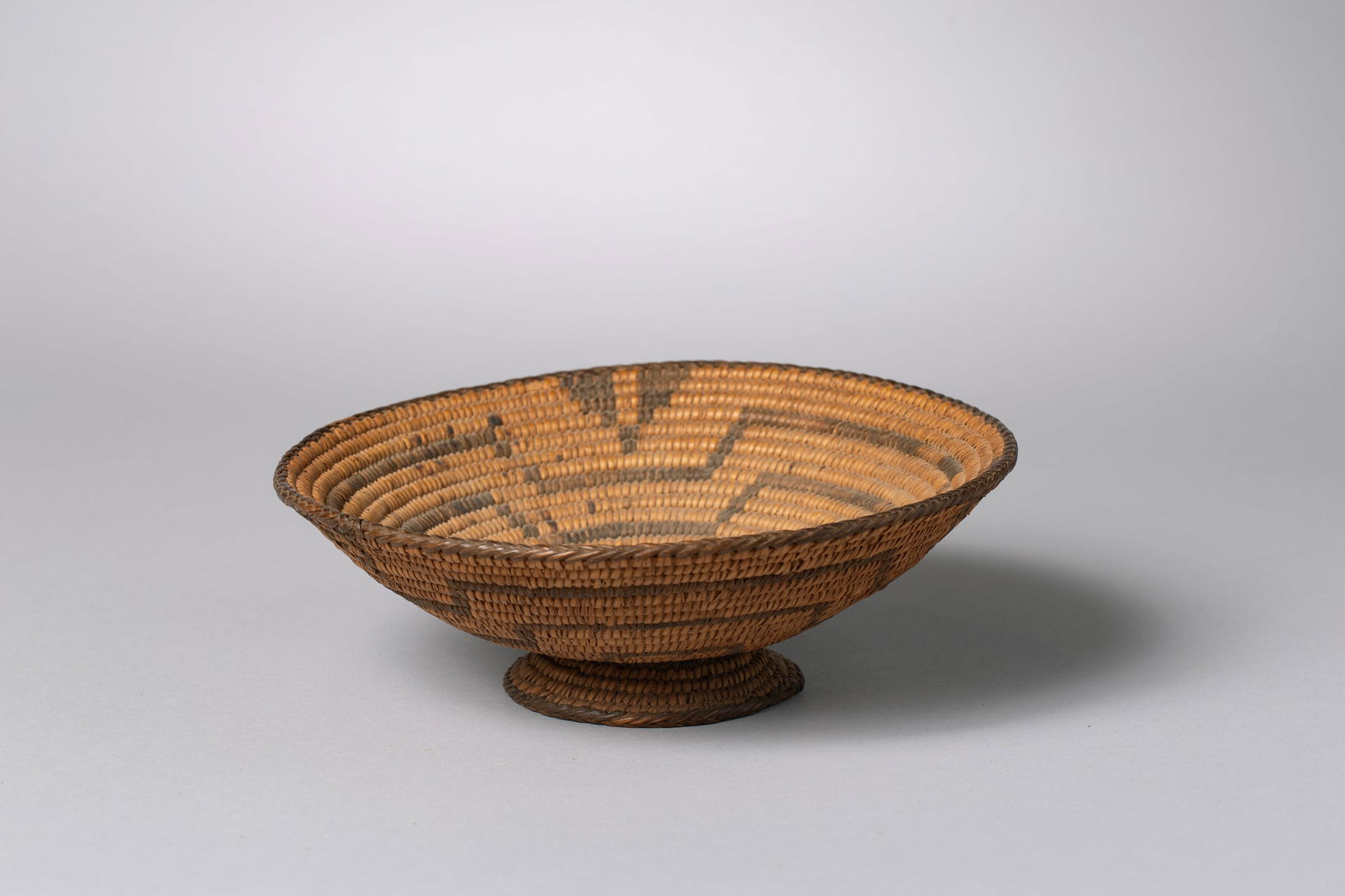 Pima Basket on Pedestal: Shallow tray featuring a maze design, made of willow and devil's claw3" height, 8.5" diameter