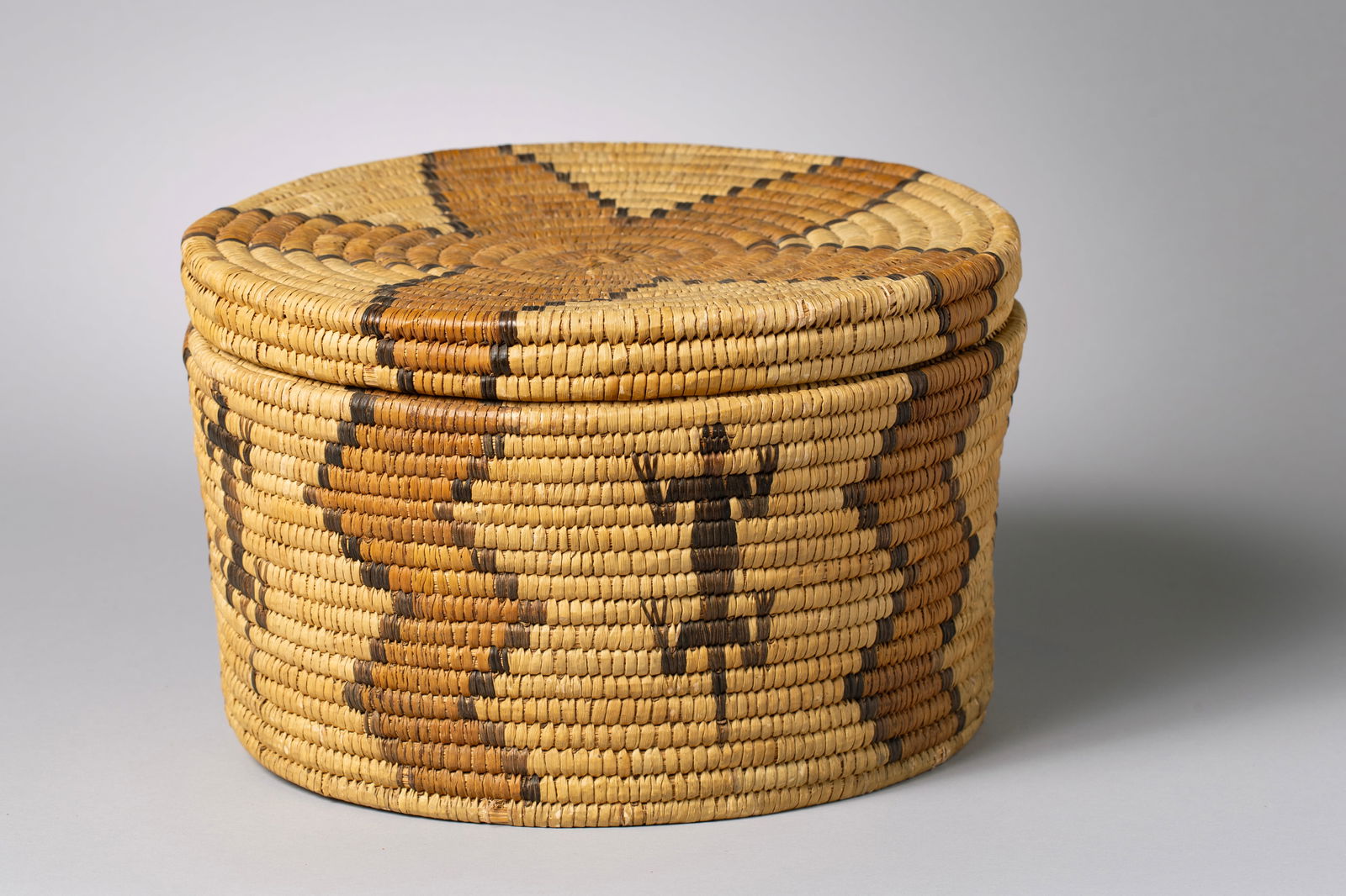 Polychrome Pictorial Pima Lidded Basket: Coiled lidded basket, of yucca and devils claw featuring anthropomorphic figures as well as a star design element on the lid and extending onto the body of the basket12" Diameter Body, 8" Height, Lid