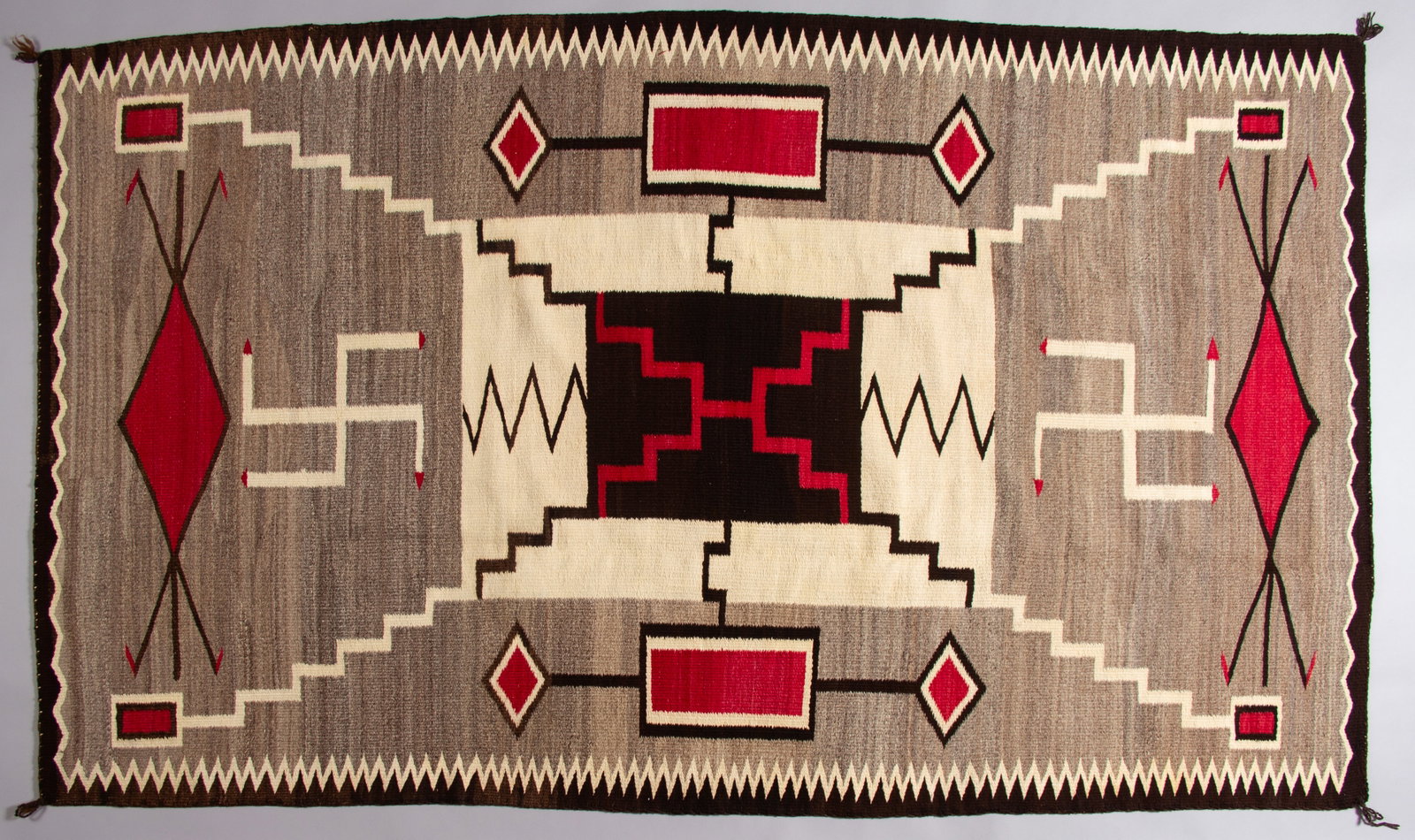 Navajo Storm Pattern Rug JBMoore, Ca 1920s: A beautiful large storm pattern weaving depicting Plate XXVII of the J.B. Moore 1911 Catalog. The storm pattern is characterized by geometric designs linked to storms and natural elements like lightni