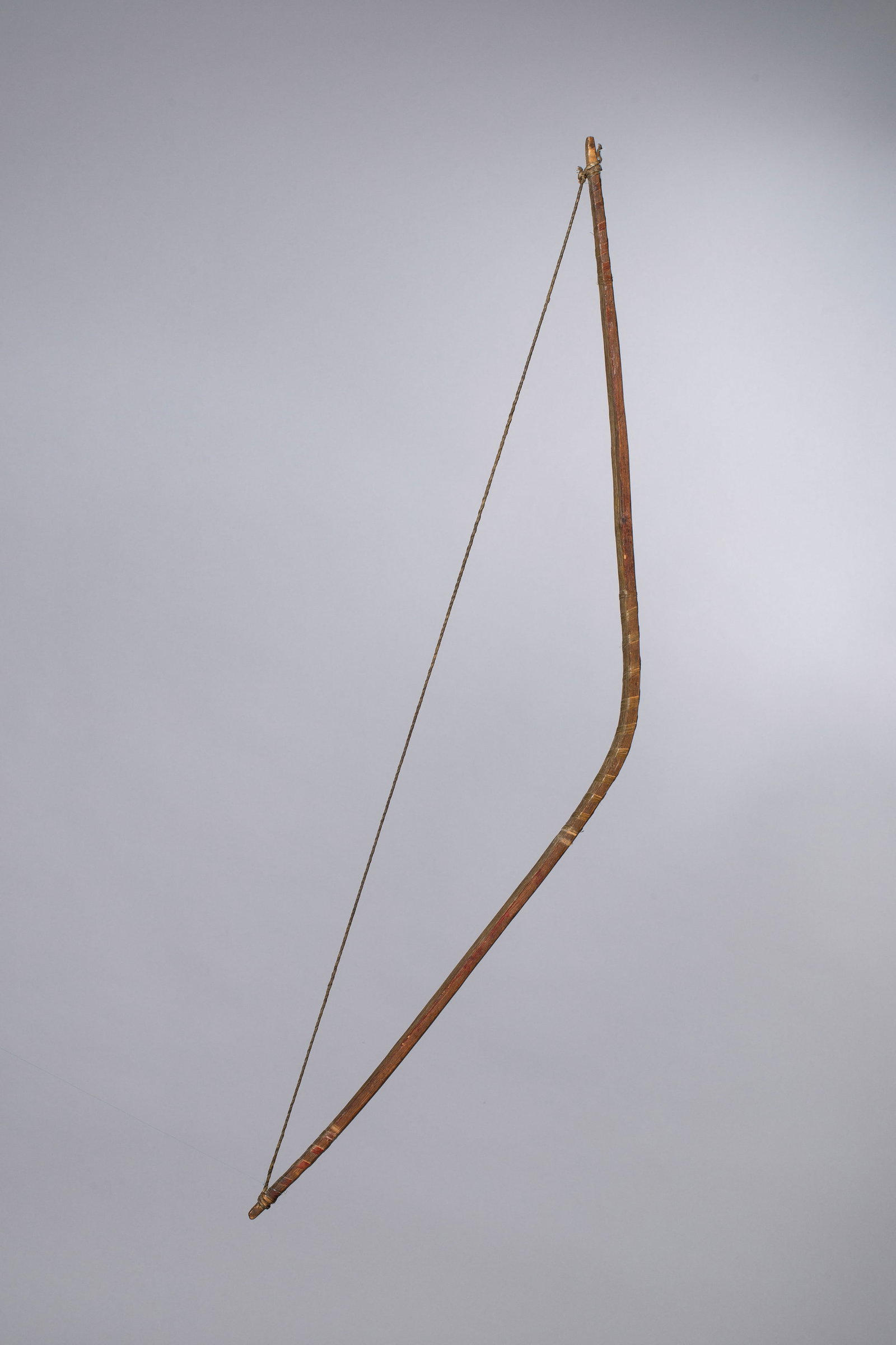 Shoshone Bow Sinew Backed with traces of Red Paint, Ca 19th or earlier: Early Shoshone bow with sinew backed, bird quill wrapping with traces of red paint still visible. Total length 37 1/2", Provenance: M.O. Mertz (Ohio), Bob Coranato