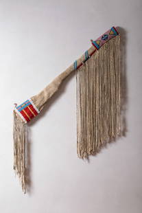 RARE EARLY Crow Beaded and Fringed Rifle Scabbard, Ca. 1870s: Crow beaded scabbard of tapering form, sinew sewn in classic bead colors, decorated on the butt with applied strips of red wool trade cloth with solid bands of beads, a beaded hide panel on point, dec