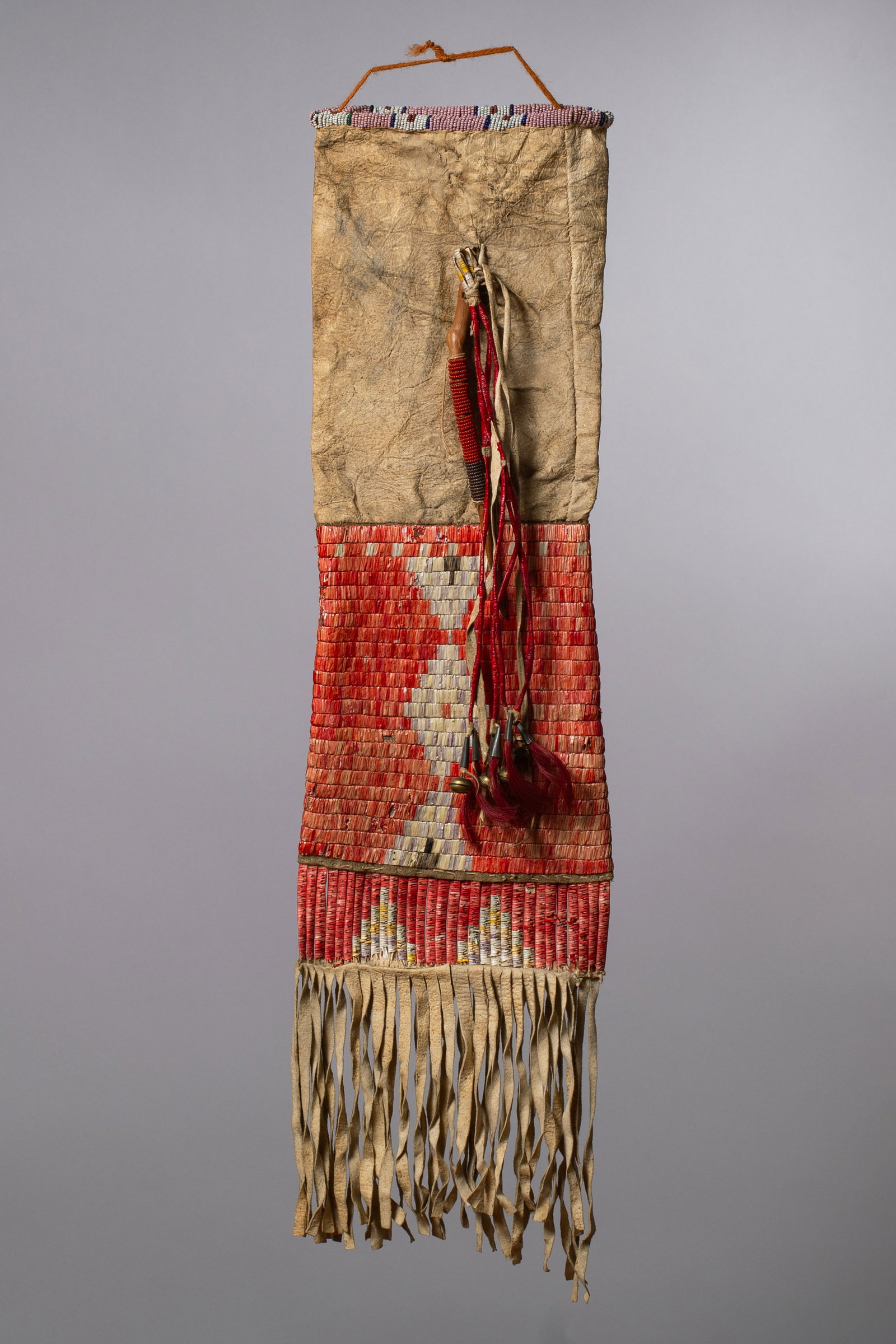 Sioux Beaded and Quilled Pipe Bag, Ca 1880s-90s: The bag is constructed out of native tanned hide, sinew sewn along beaded opening with dyed porcupine quills. Opening consists of white, pink, navy and red beads. The base panel is decorated with natu