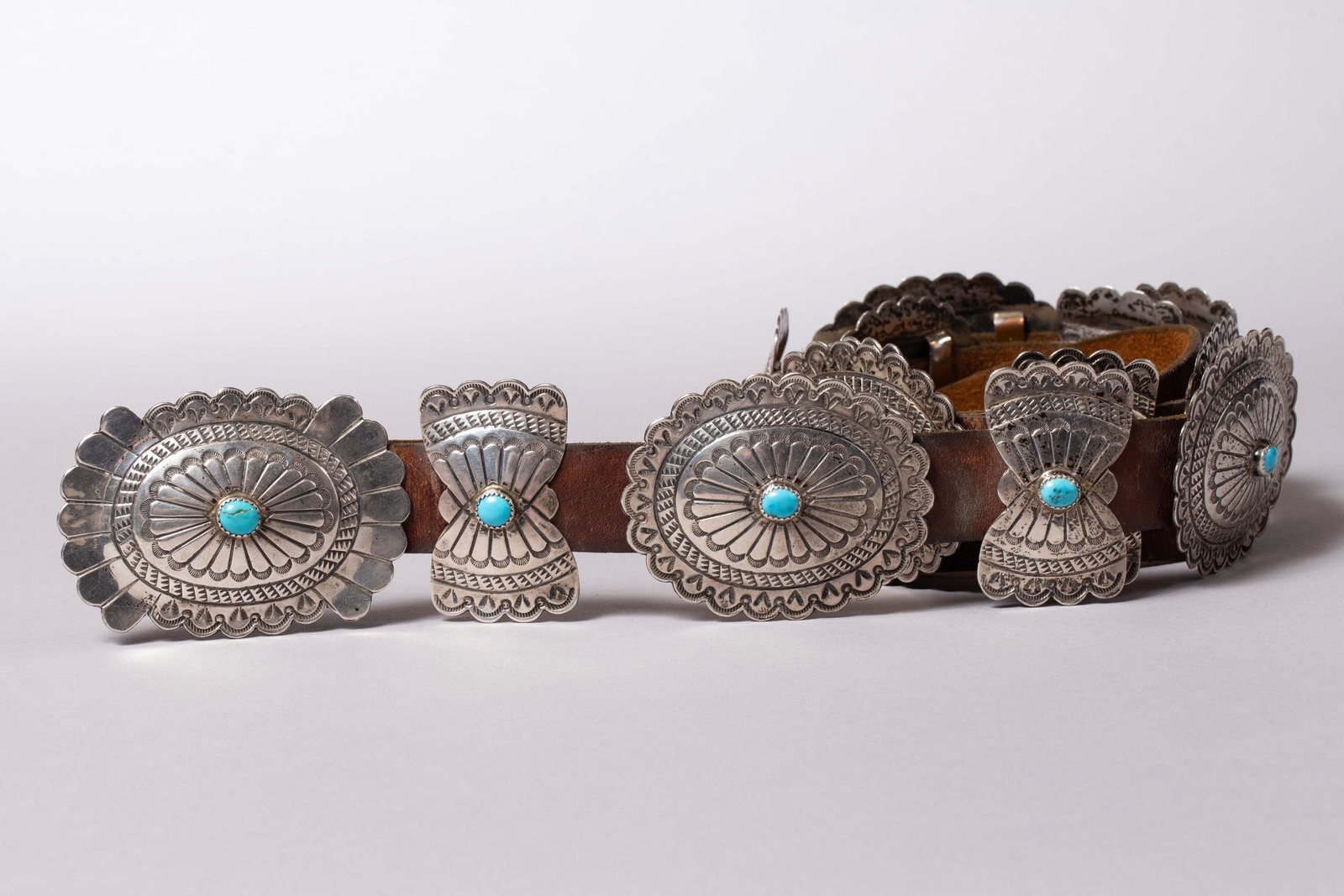 Navajo Sterling Silver Concho Belt with Turquoise Cabachons, Henry Blackgoat: Six sterling silver conchos with turquoise cabochon centers, each measuring 2 1/2" x 2 1/8", seven butterfly conchos with turquoise cabachon centers each measuring 1 1/4" x 2 1/8", buckle with turquoi